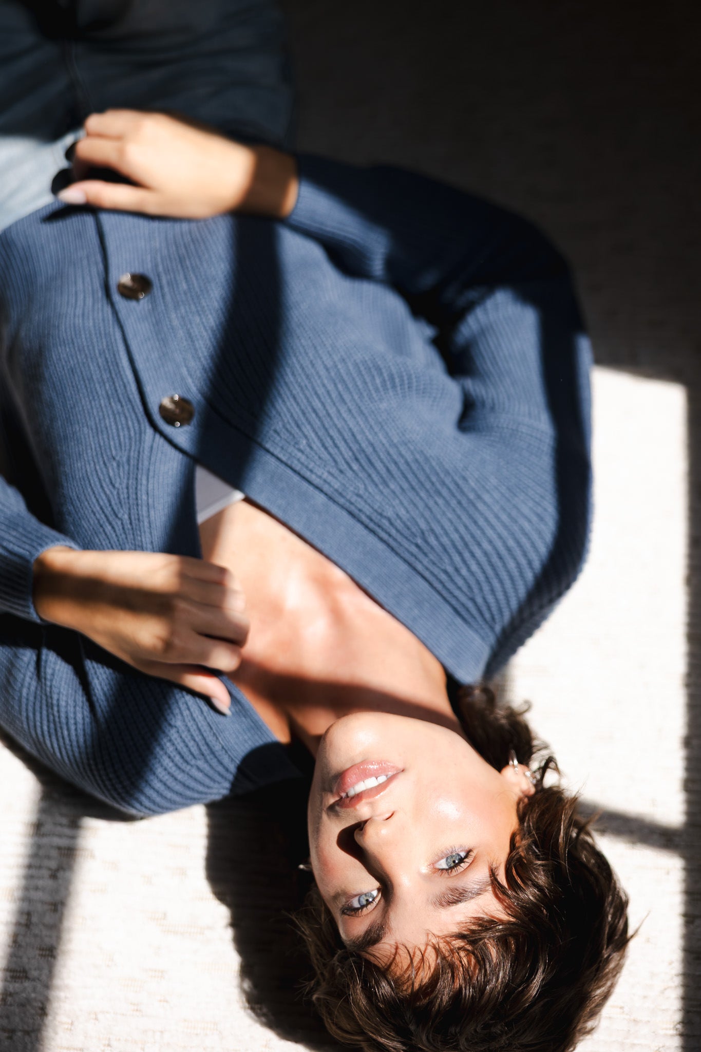 Modal posing lying on floor wearing Chunky Knit Women's Cropped Cardigan In Oxford