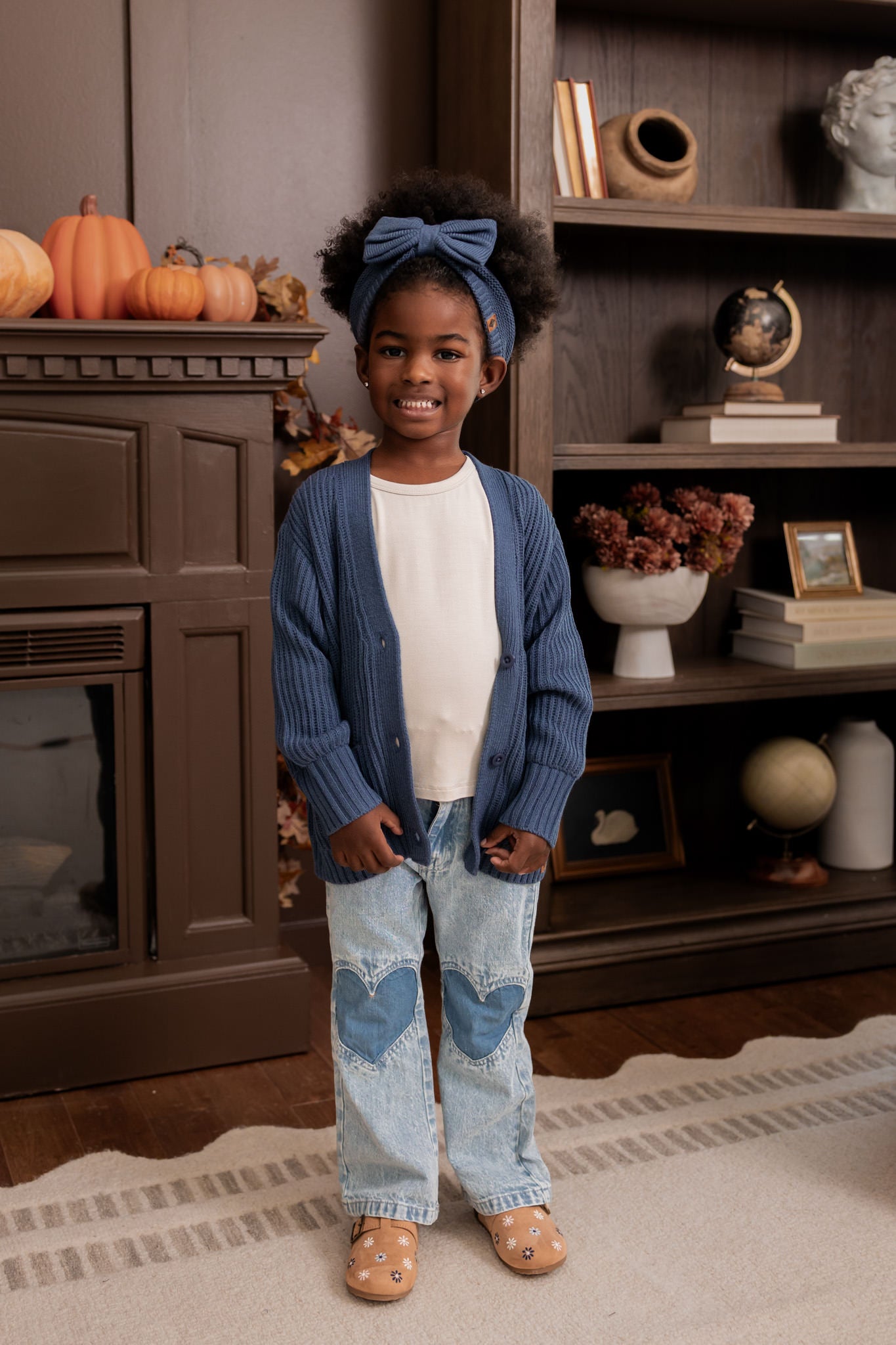 Girl wearing Chunky Knit Oversized Cardigan in Oxford over White T-shirt, blue jeans and Chunky knit bow headband in oxford