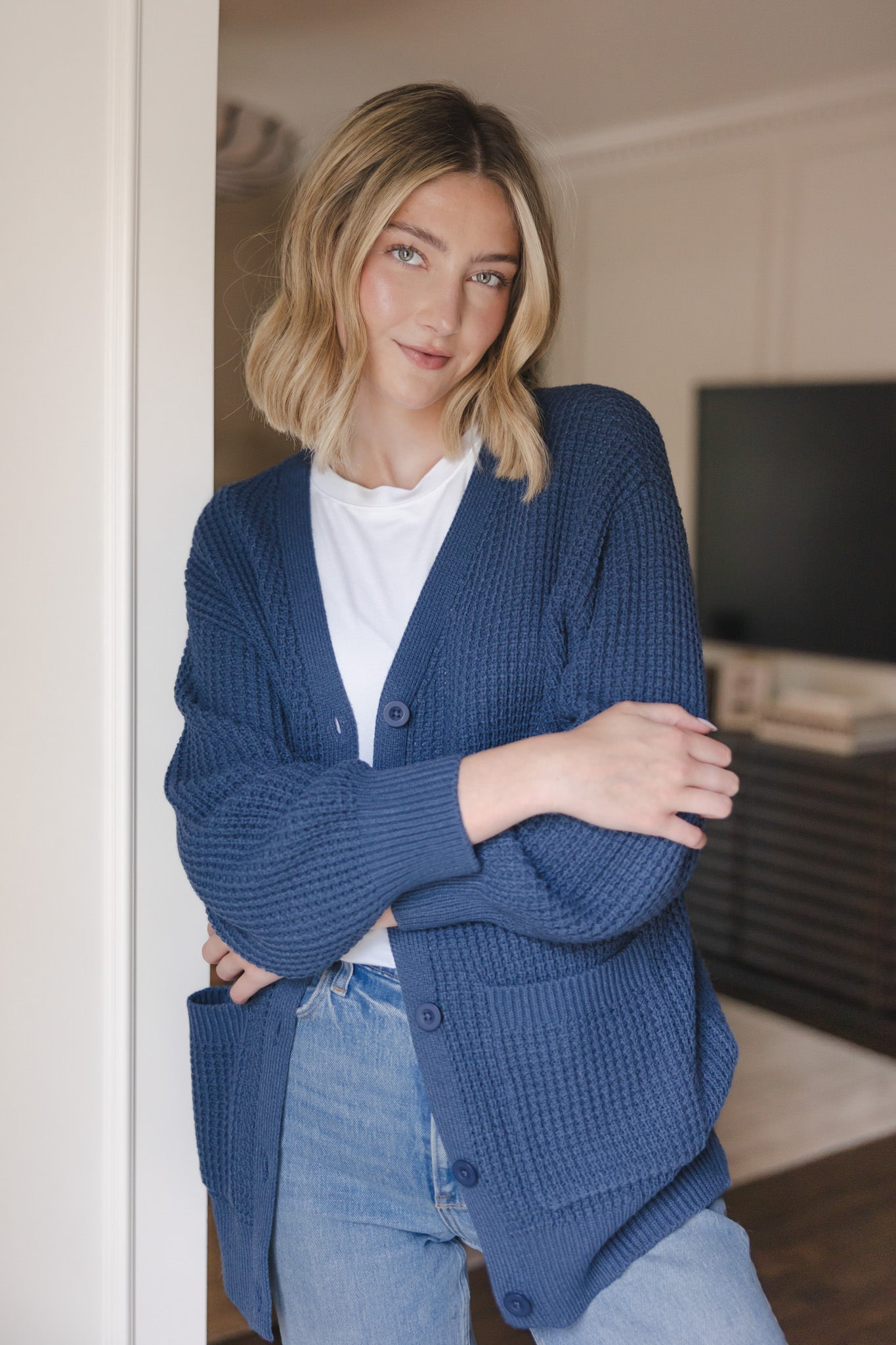 Modal wearing Chunky Knit Women's Waffle Cardigan in Oxford over white T-shirt and blue jeans