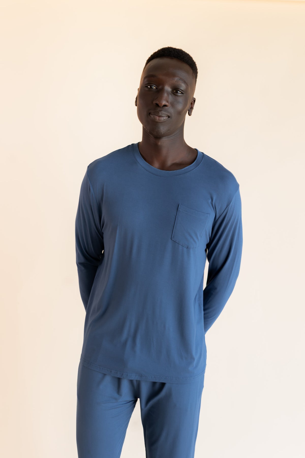 Model wearing Men's Jogger Set in Oxford on a beige background
