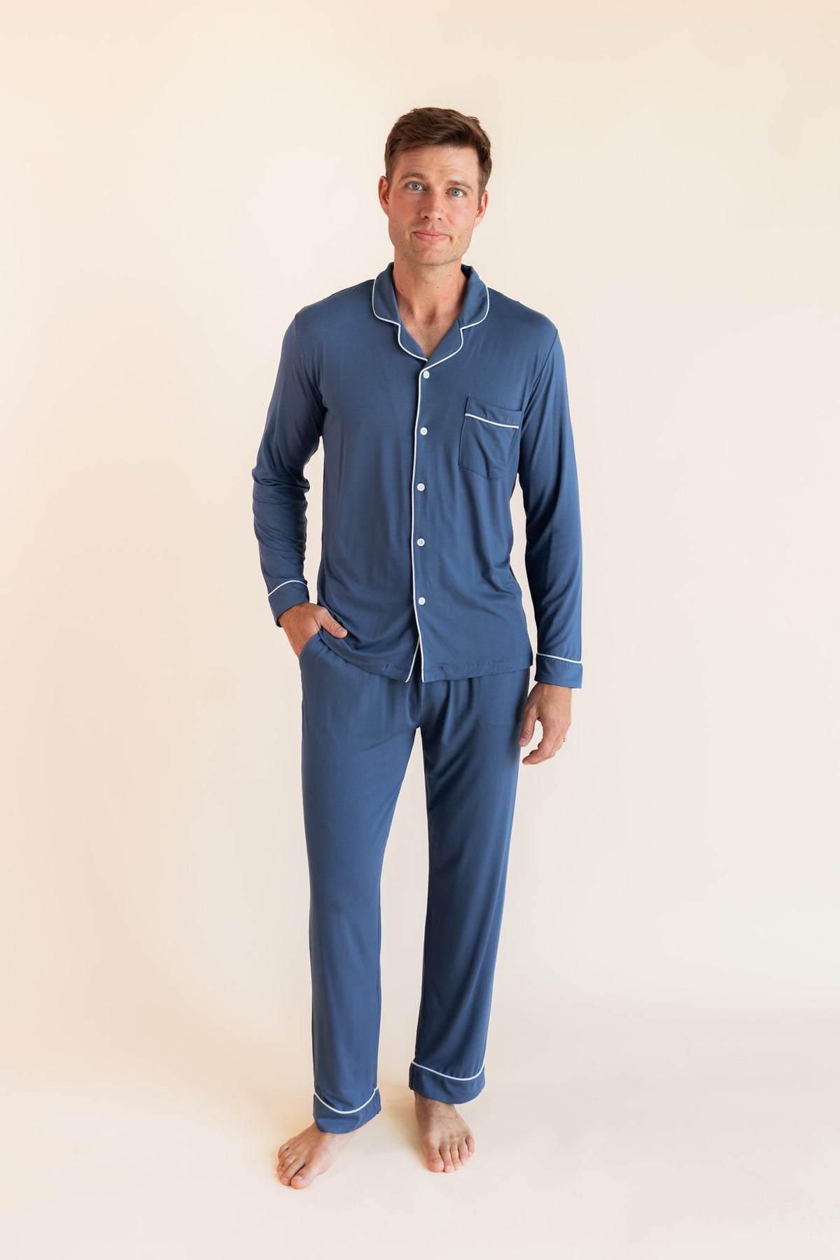 Model wearing Men's Long Sleeve Pajama Set in Oxford on a beige background