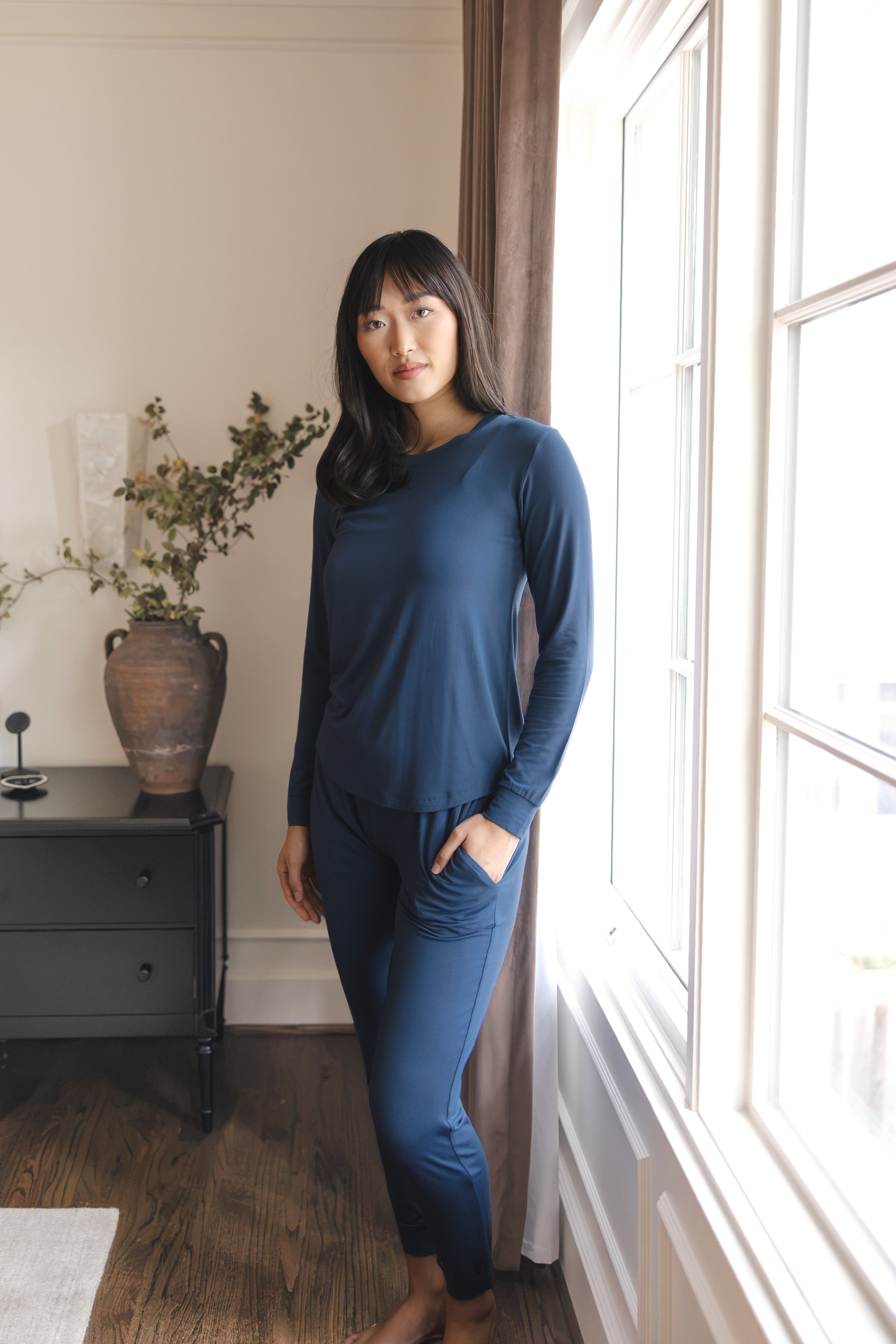 Modal wearing Women's Jogger Pajama Set in Oxford standing near a glass window