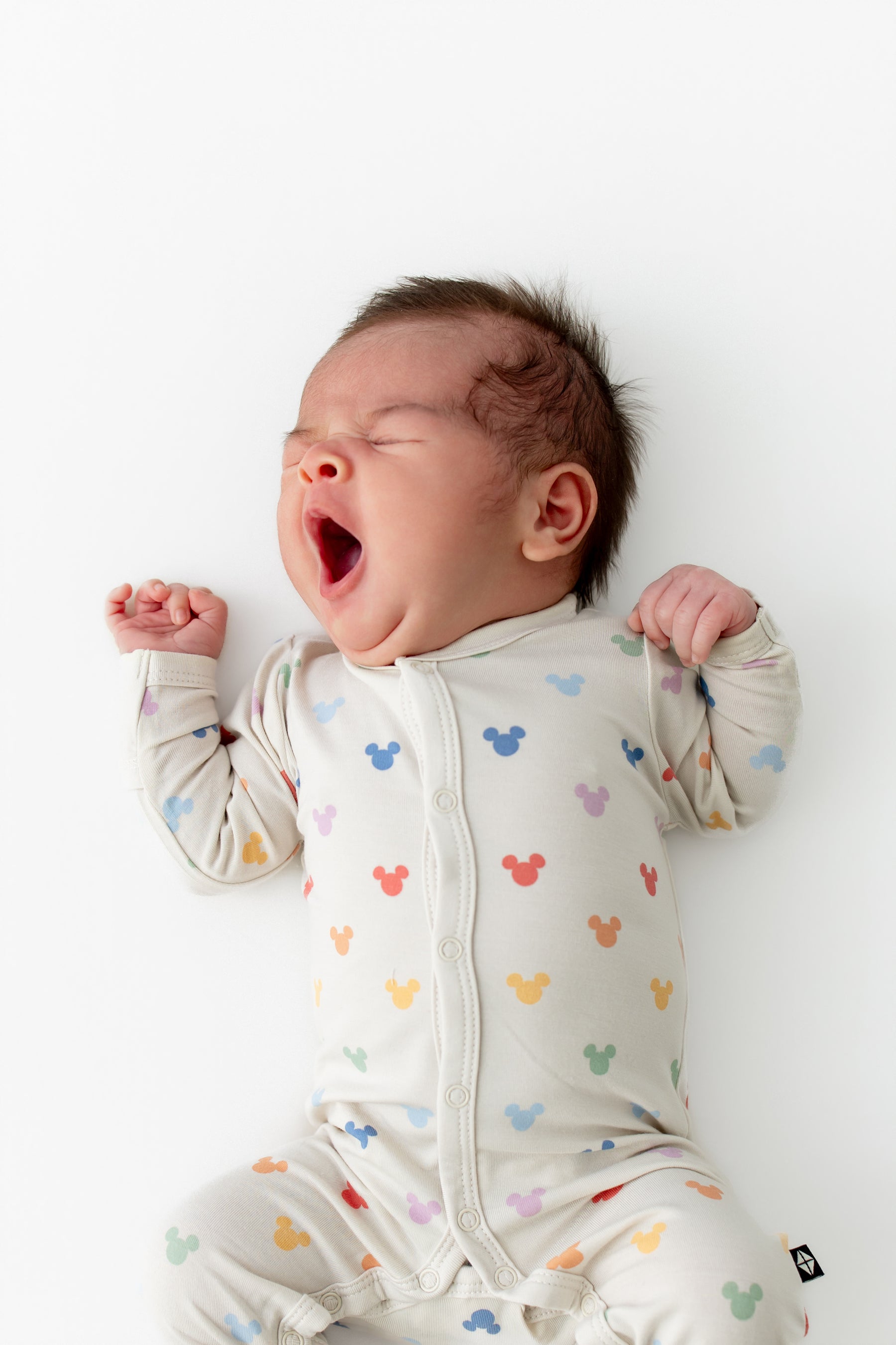 Baby yawning weairng pastel mickey head printed romper