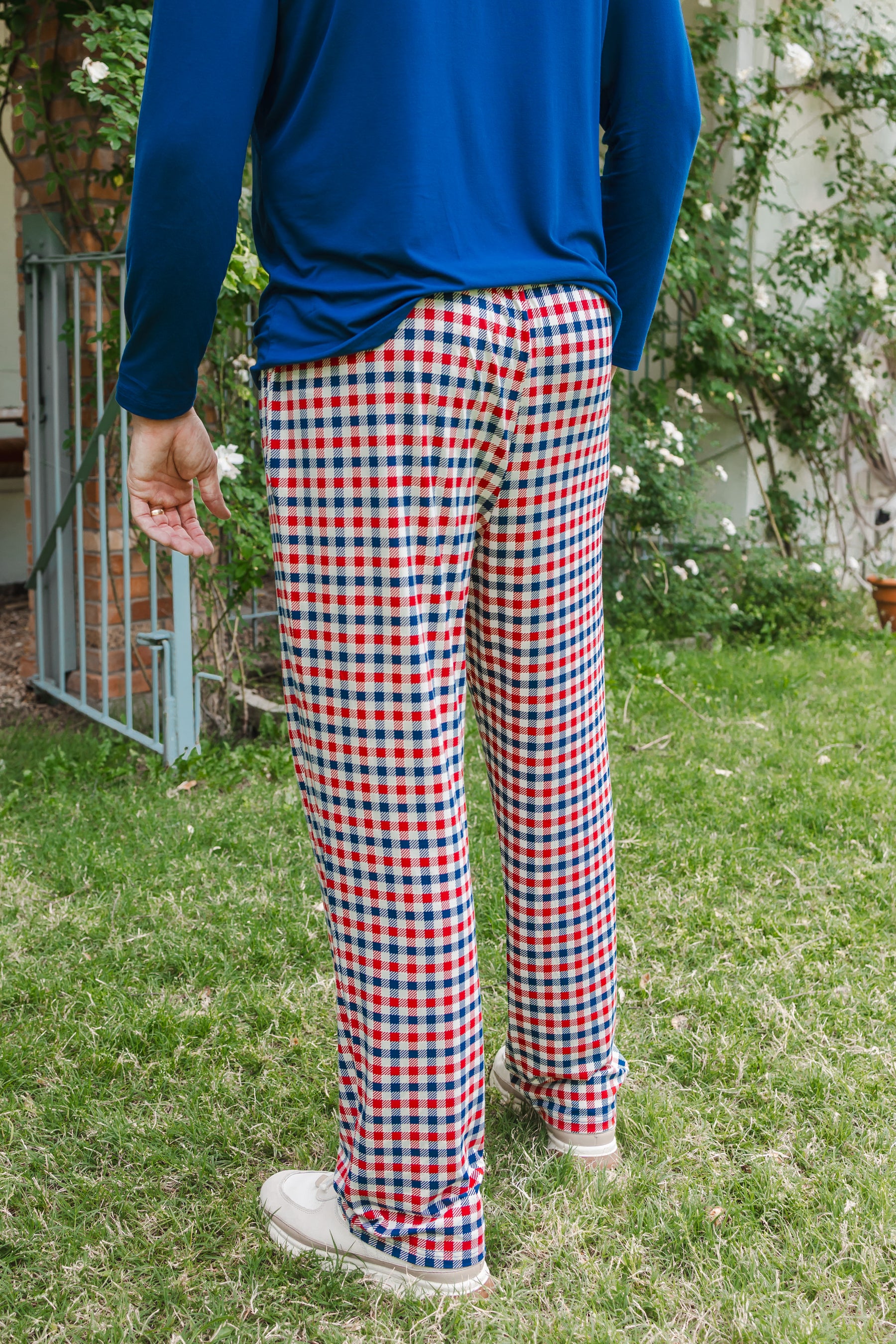 Back side of Men's lounge pant in red blue and white Patriotic Gingham check print under a Men's Long Sleeve Henley Top in Tahoe outdoors