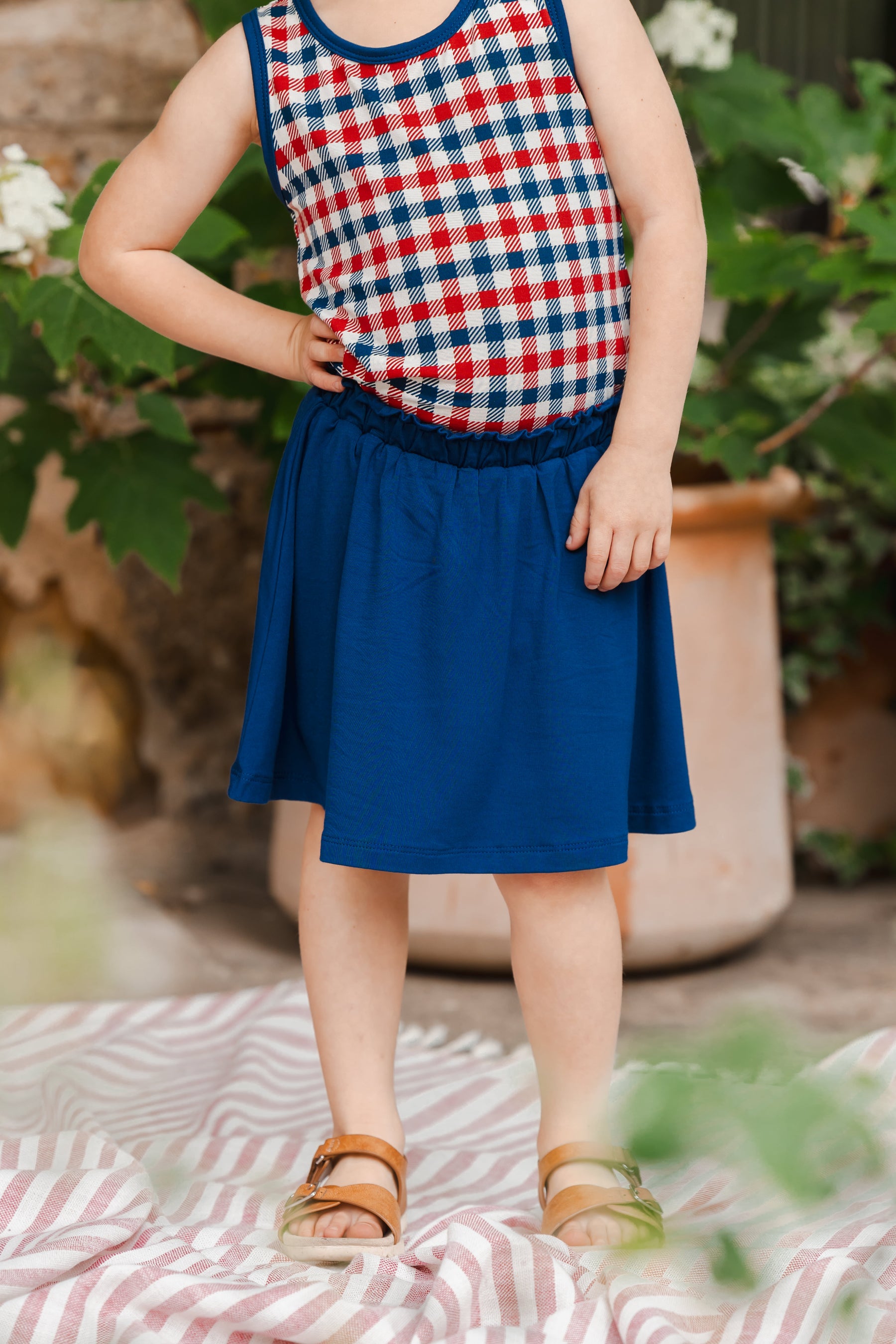 Toddler tank top in red blue and white Patriotic Gingham check print over a Tahoe skort and sandles