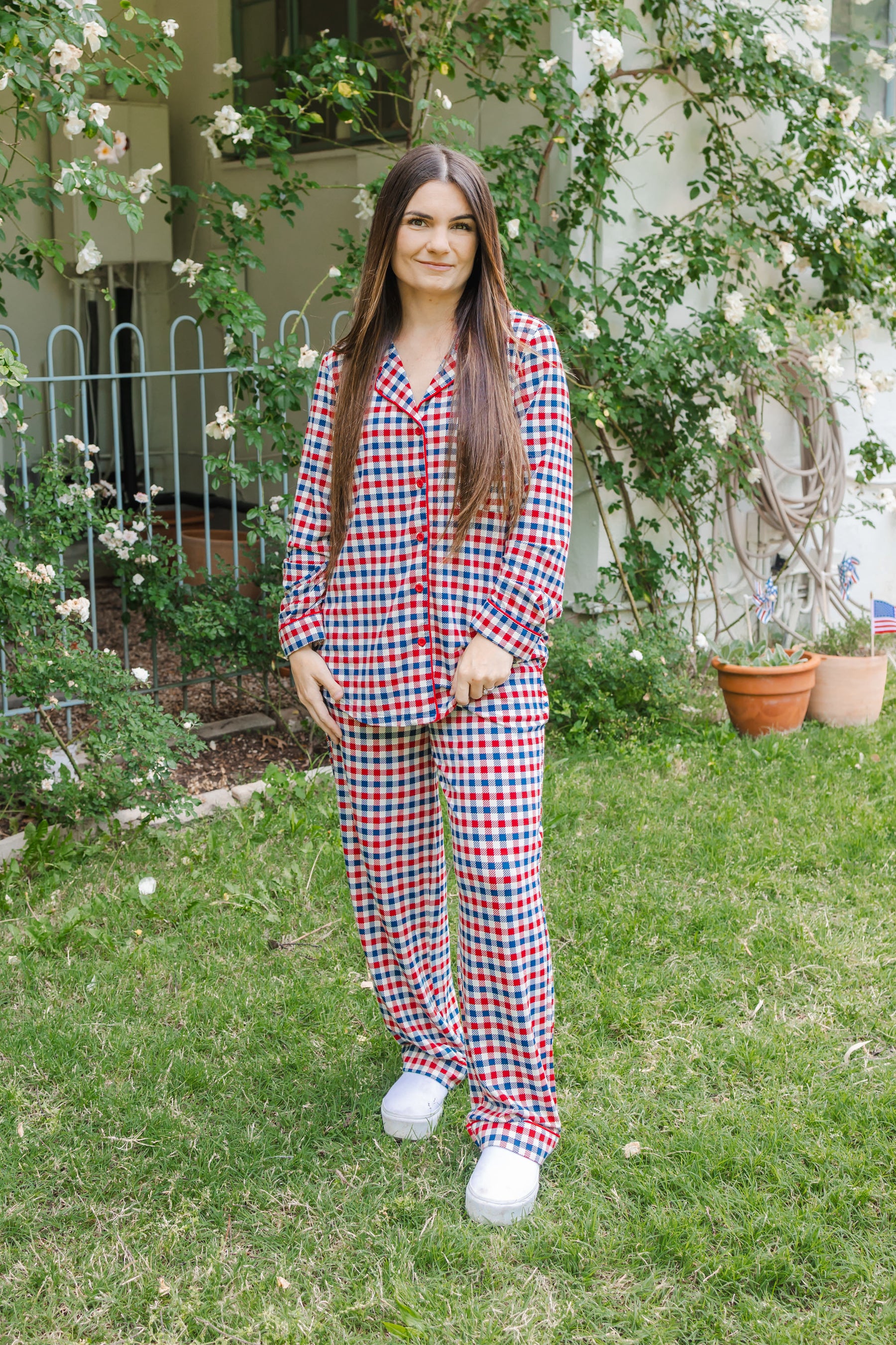 Woman wearing a red white and blue Patriotic Gingham check print long sleeve pajama set outdoors
