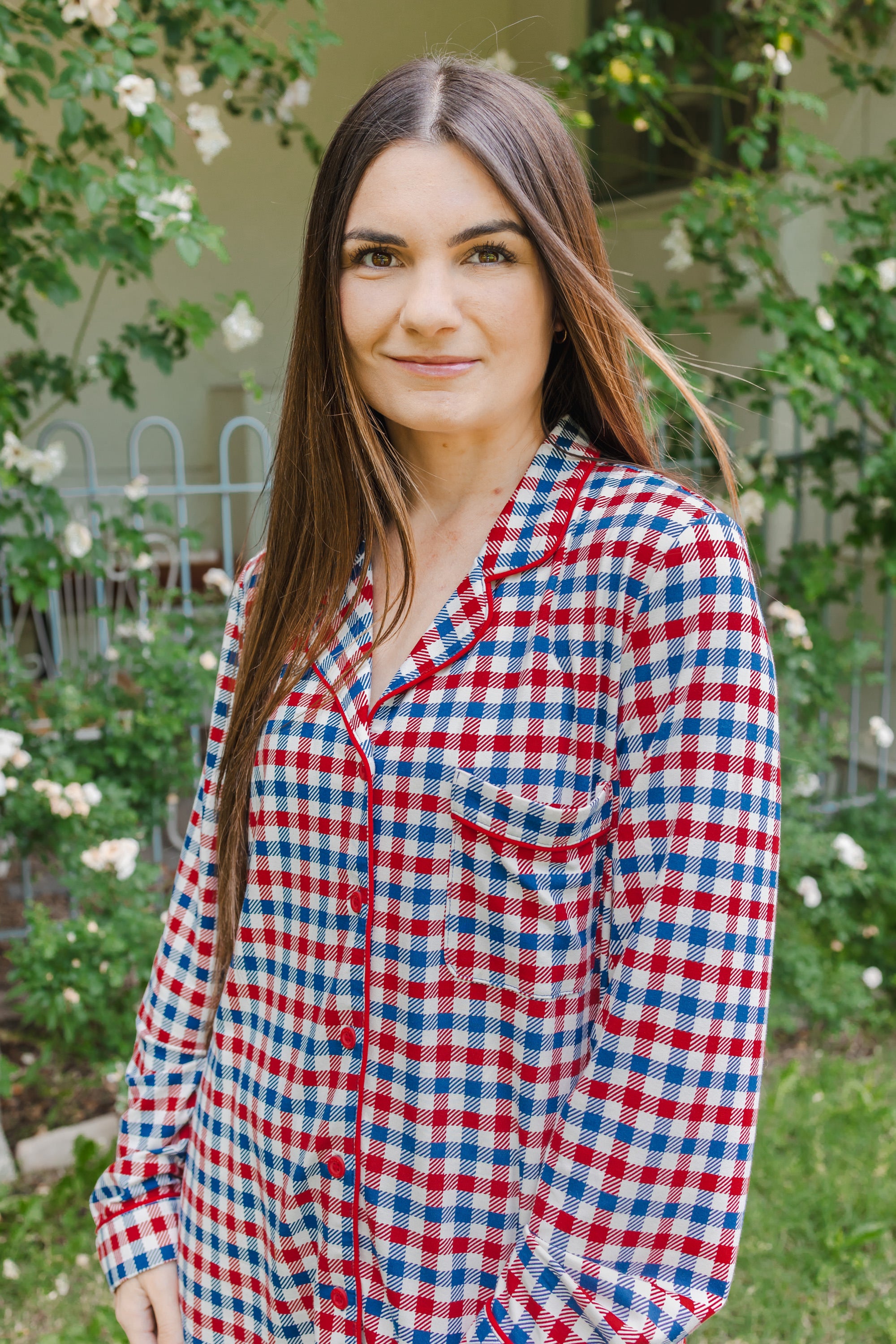 Woman modeling a red white and blue Patriotic Gingham check print long sleeve pajama set outdoors