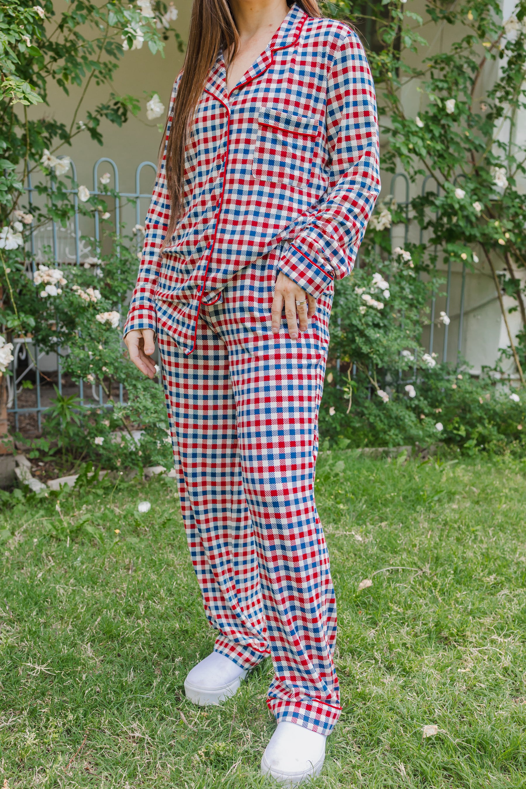 Model wearing Long sleeve pajama set in red white and blue Patriotic Gingham check print outdoors