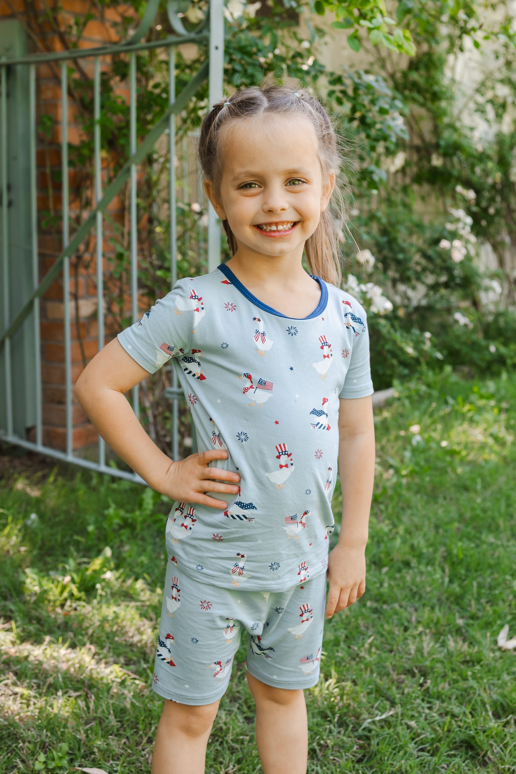 Child posing in light blue Short Sleeve Pajamas in Patriotic Goose print  outdoors