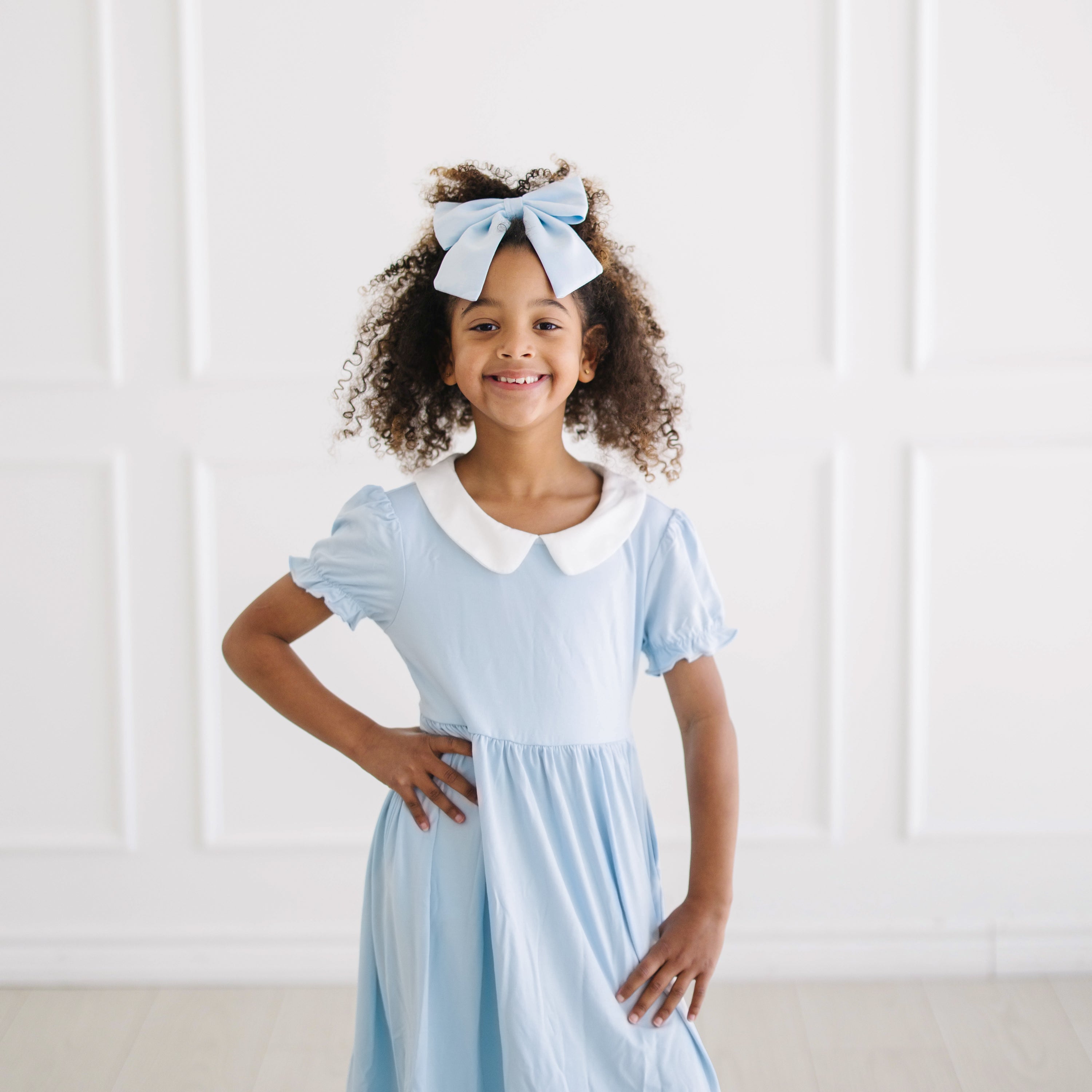 Close up of young girl modeling the Peter Pan Collar Dress in Breeze