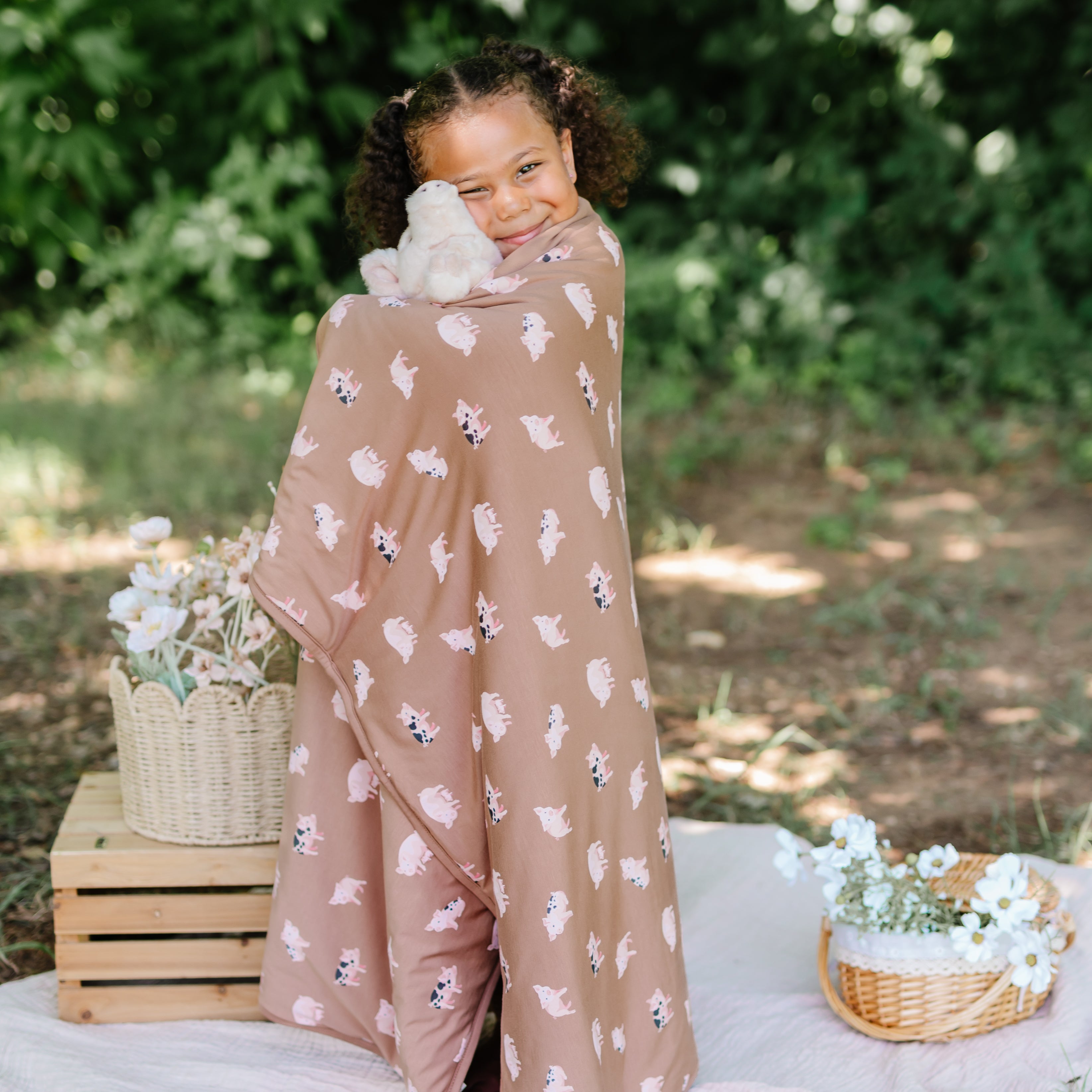 Girl wrapped in Toddler Blanket in Pig 1.0 TOG