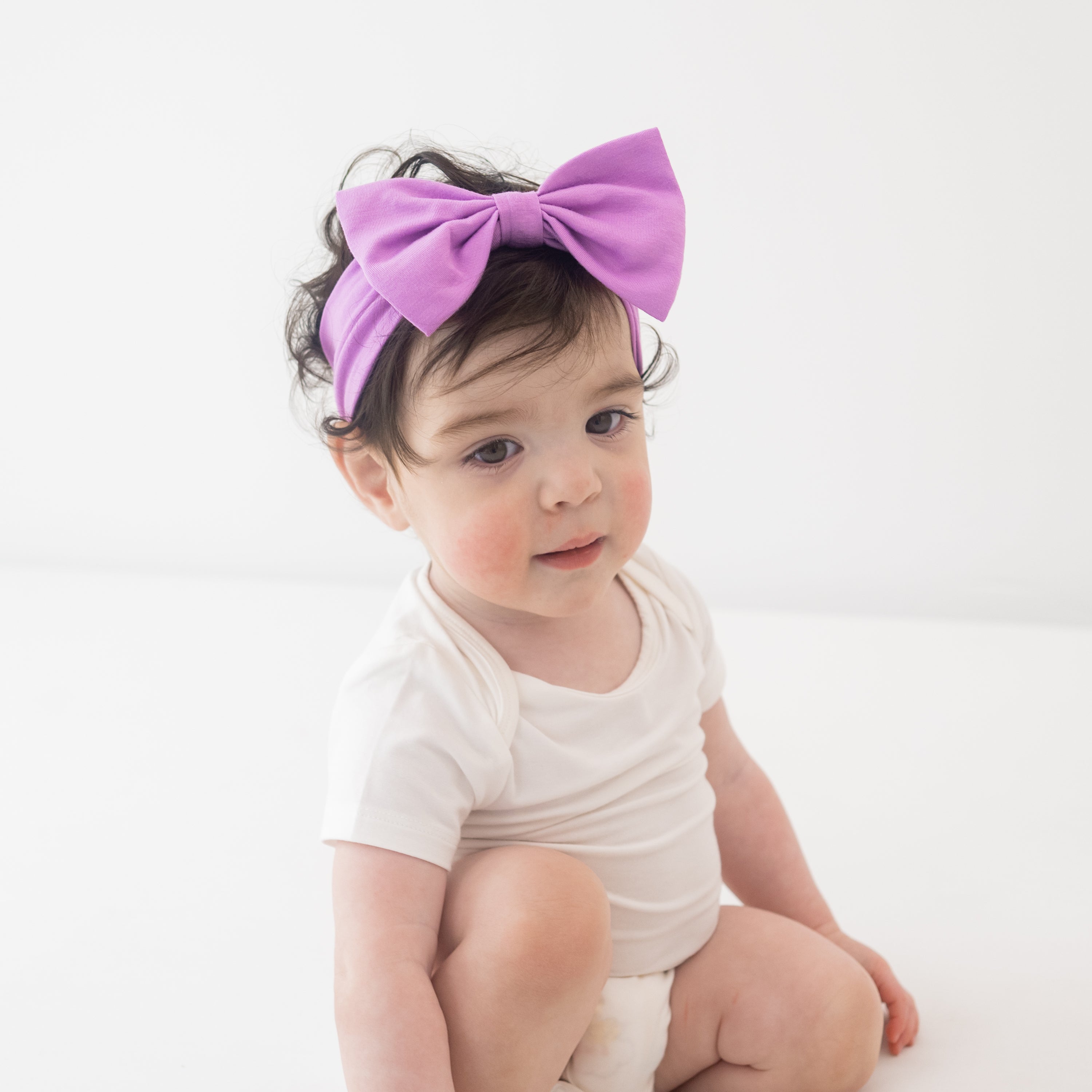 Baby wearing Bow Headband in Poi