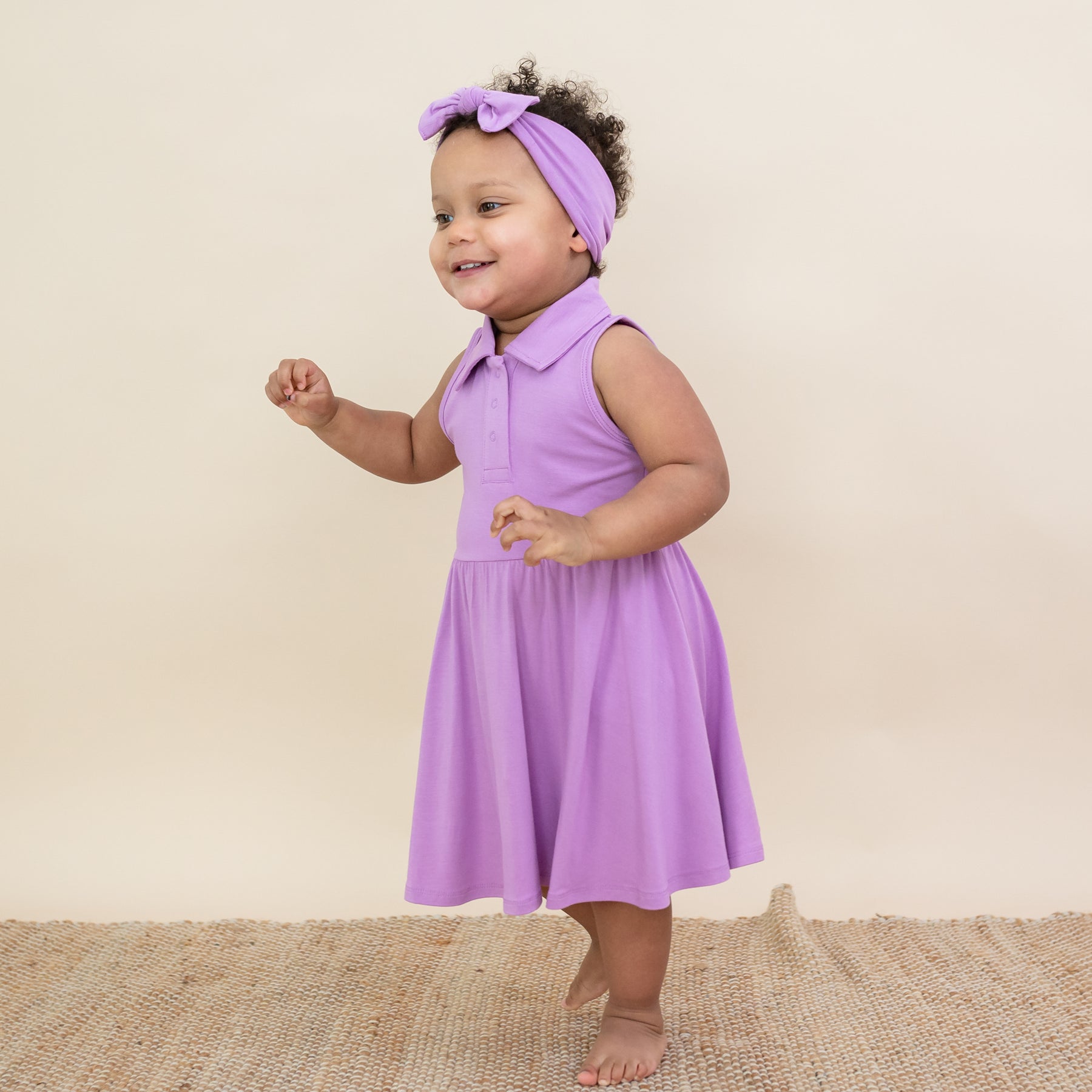 Toddler modeling Polo Bodysuit Dress in Poi