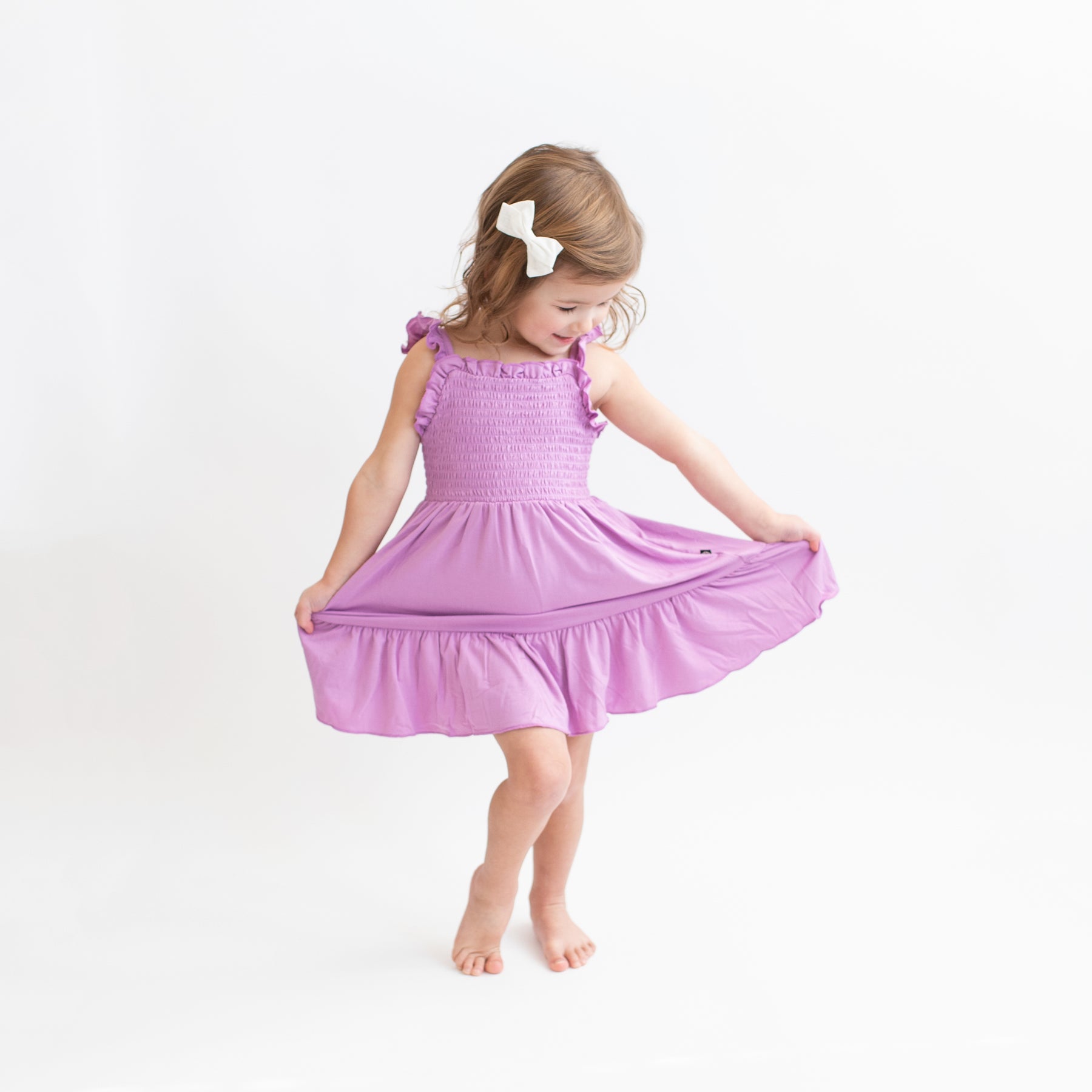 Child modeling Smocked Dress in Poi