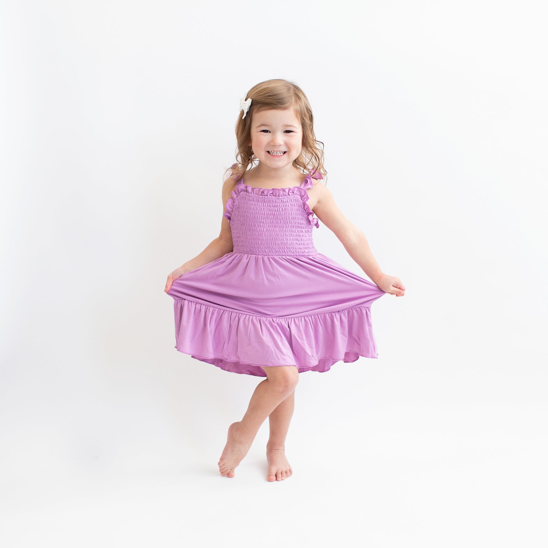 Child modeling Smocked Dress in Poi