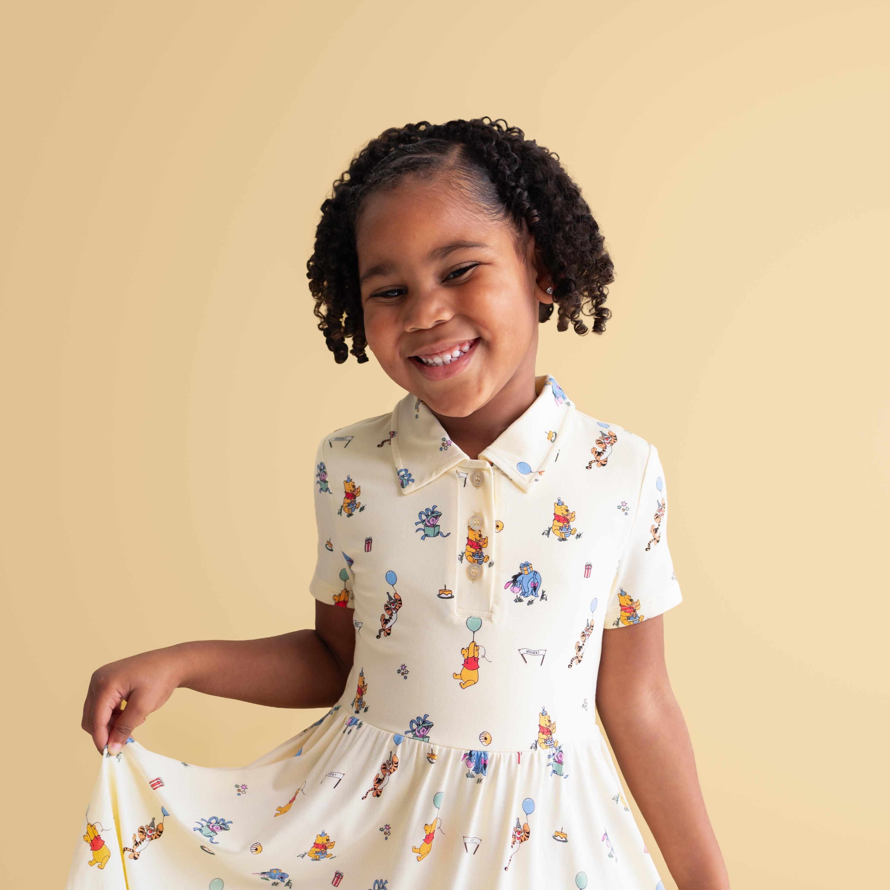 Close up of smiling girl wearing the Polo Dress in Winnie the Pooh Celebration