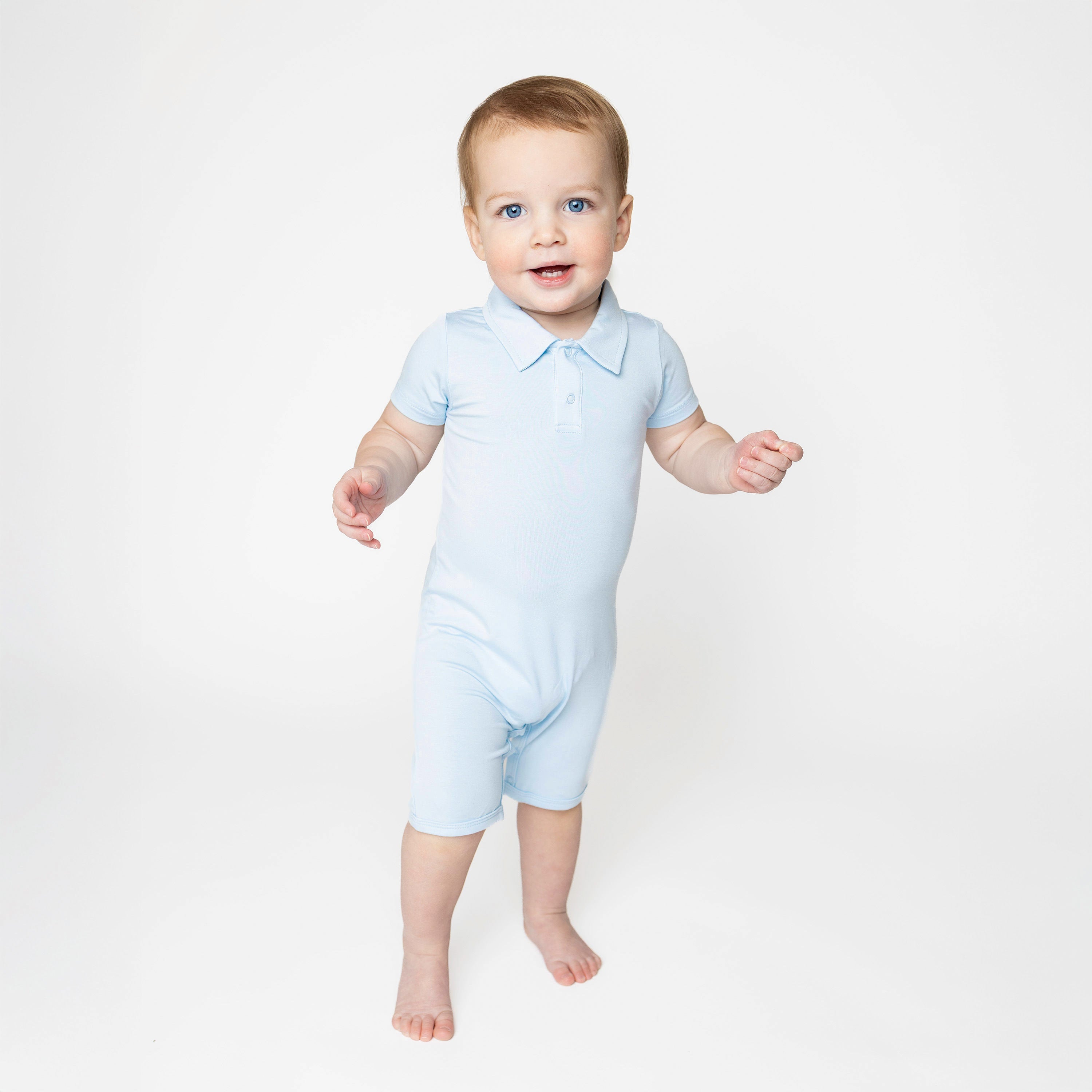 Young toddler standing in front of a white background wearing the Polo Shortall in Breeze