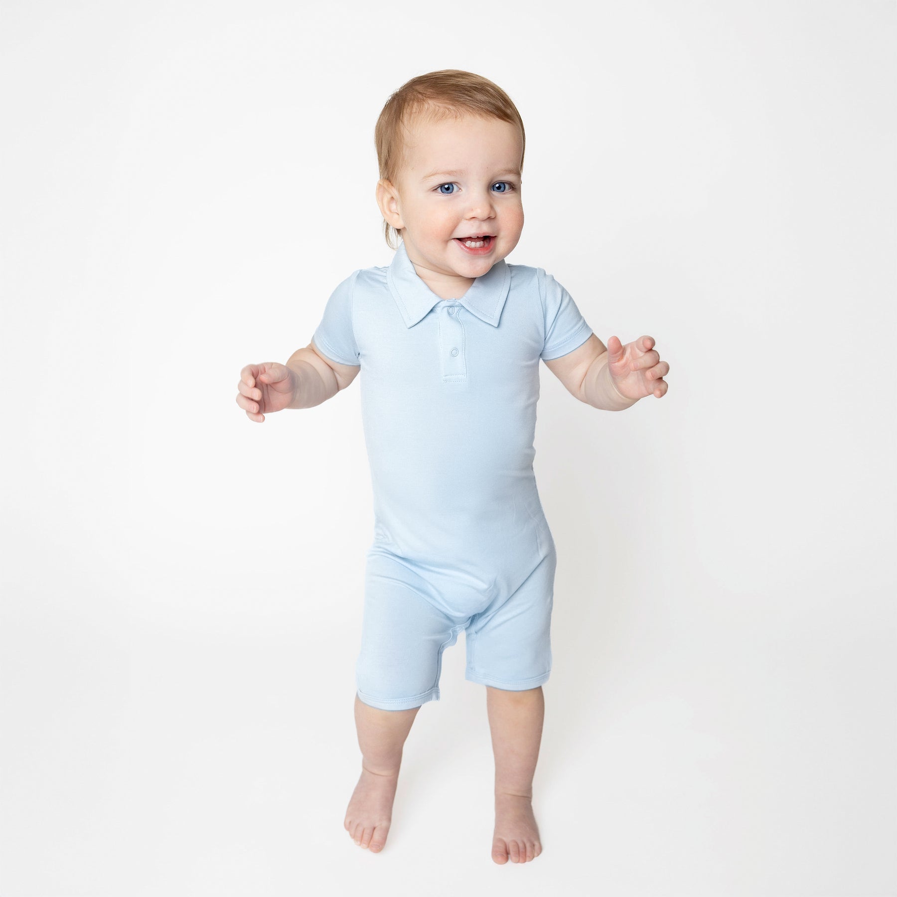 Young toddler walking wearing the Polo Shortall in Breeze