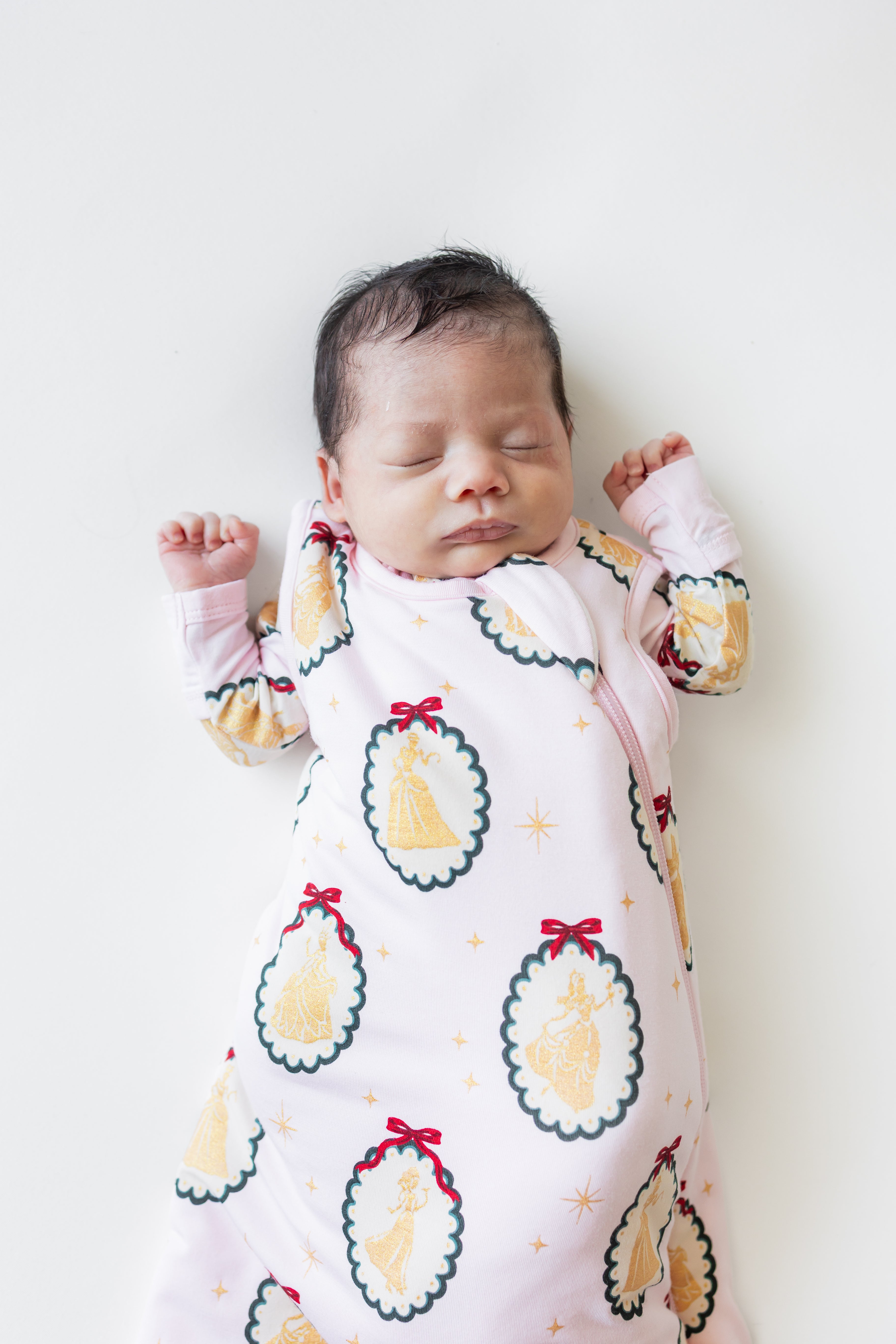 Close up of Baby sleeping in Sleep Bag in Princess Holiday Portraits 1.0 print on a beige background