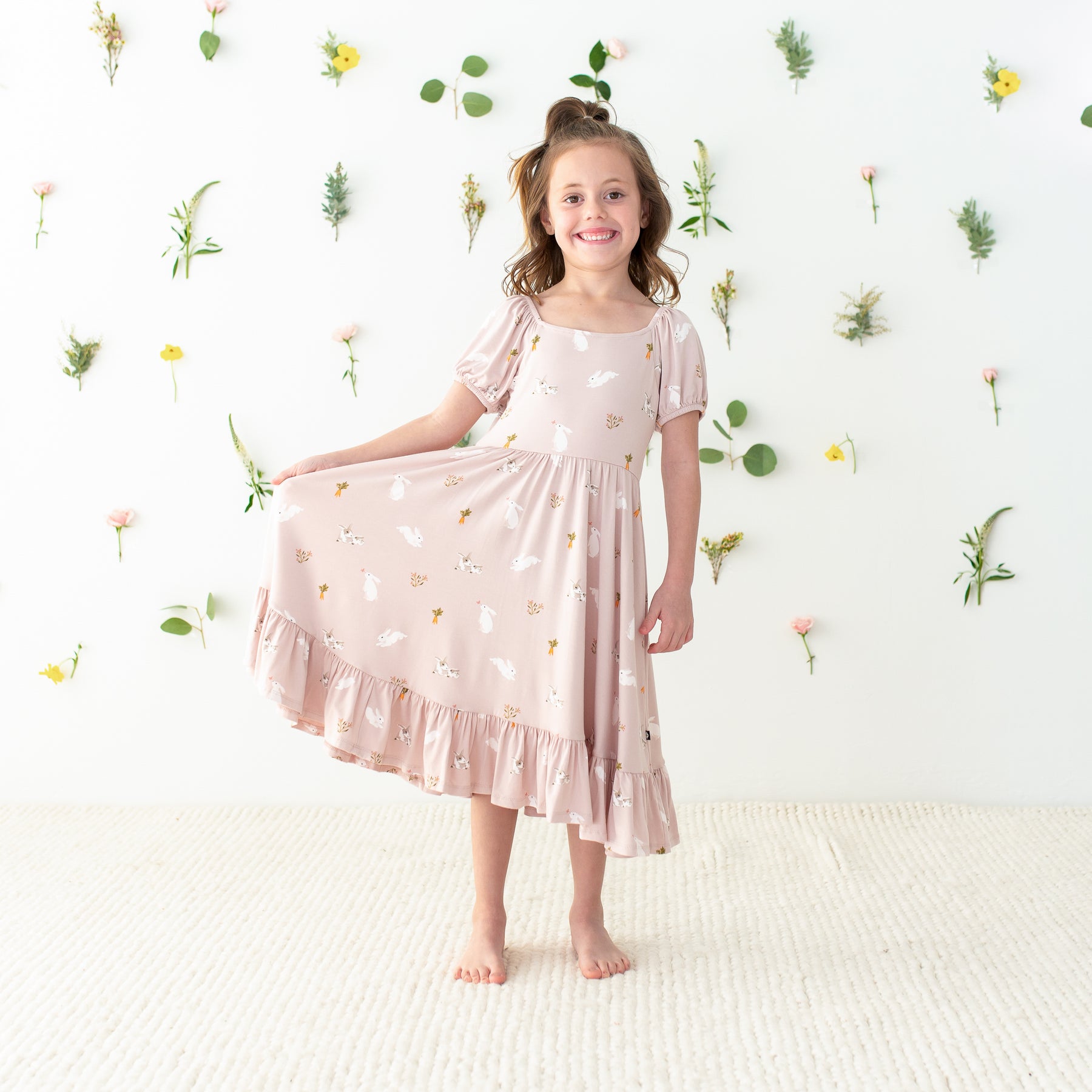 Child modeling in Puff Sleeve Twirl Dress in Blush Rabbit