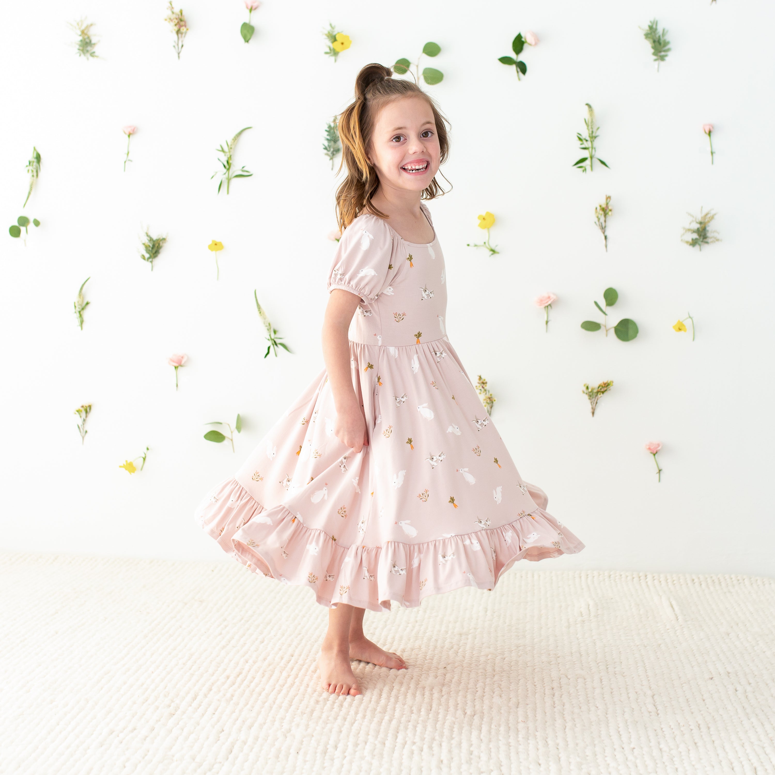 Child twirling in Puff Sleeve Twirl Dress in Blush Rabbit