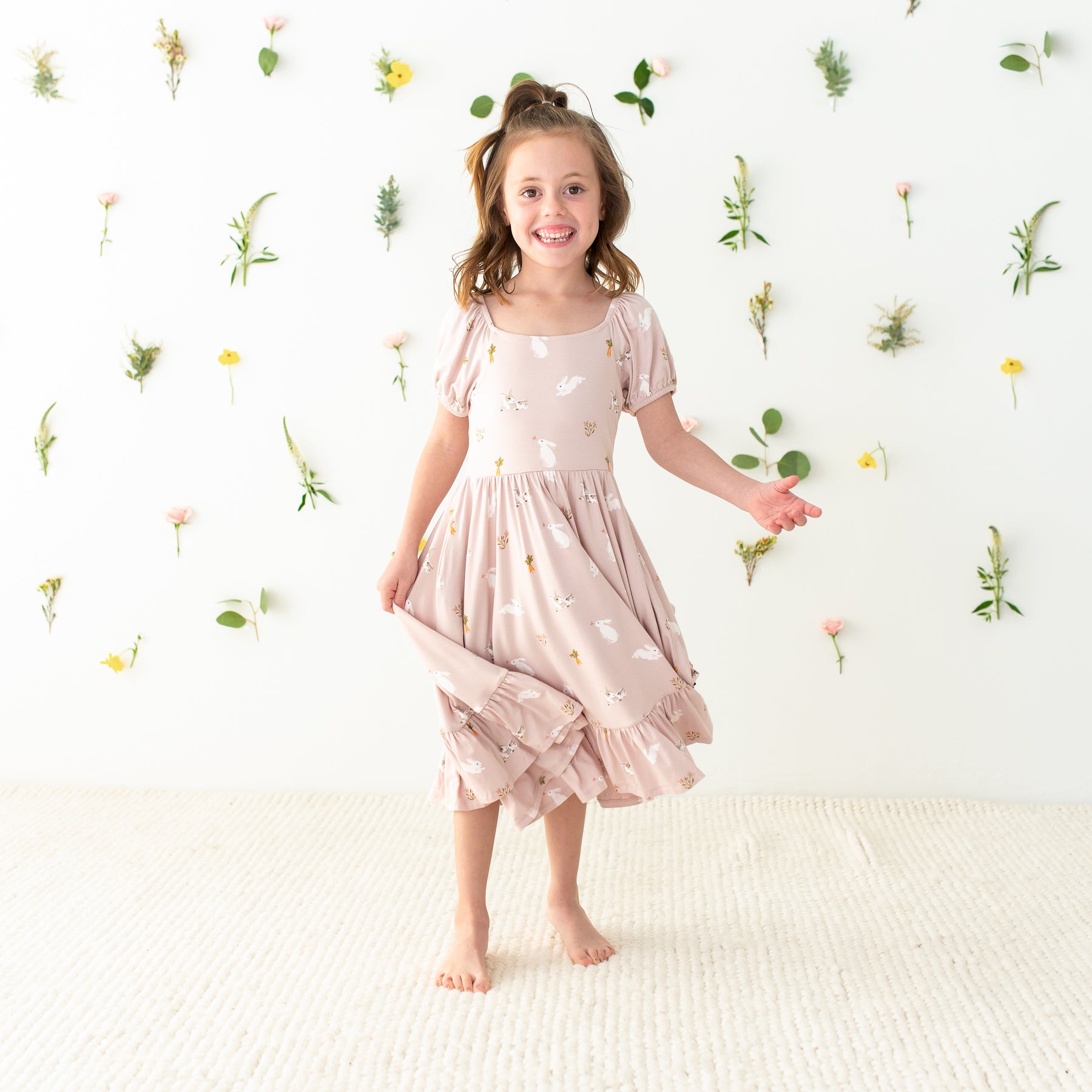 Child twirling in Puff Sleeve Twirl Dress in Blush Rabbit