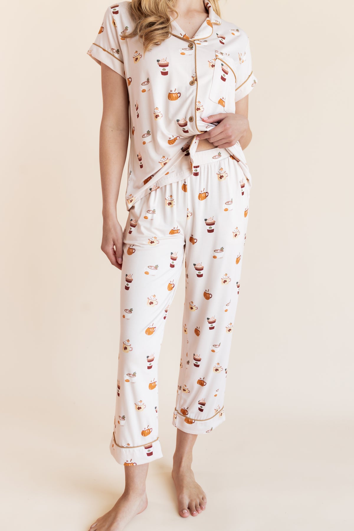 Modal showcasing the top part of pajamas of Women's Short Sleeve Cropped Pajama Set with Pumpkin Spice Latte print on a beige background