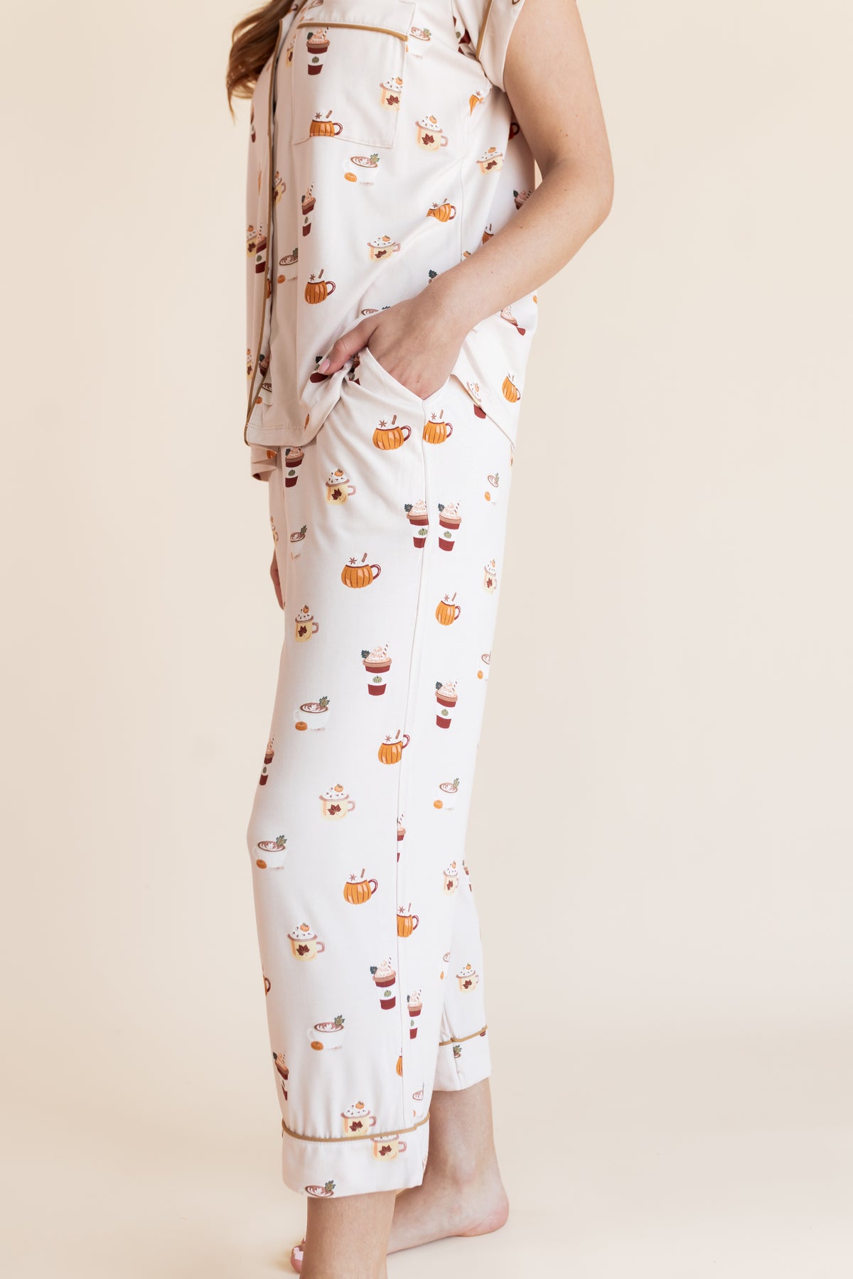 Modal showcasing the pajama pockets  on Women's Short Sleeve Cropped Pajama Set with Pumpkin Spice Latte print on a beige background