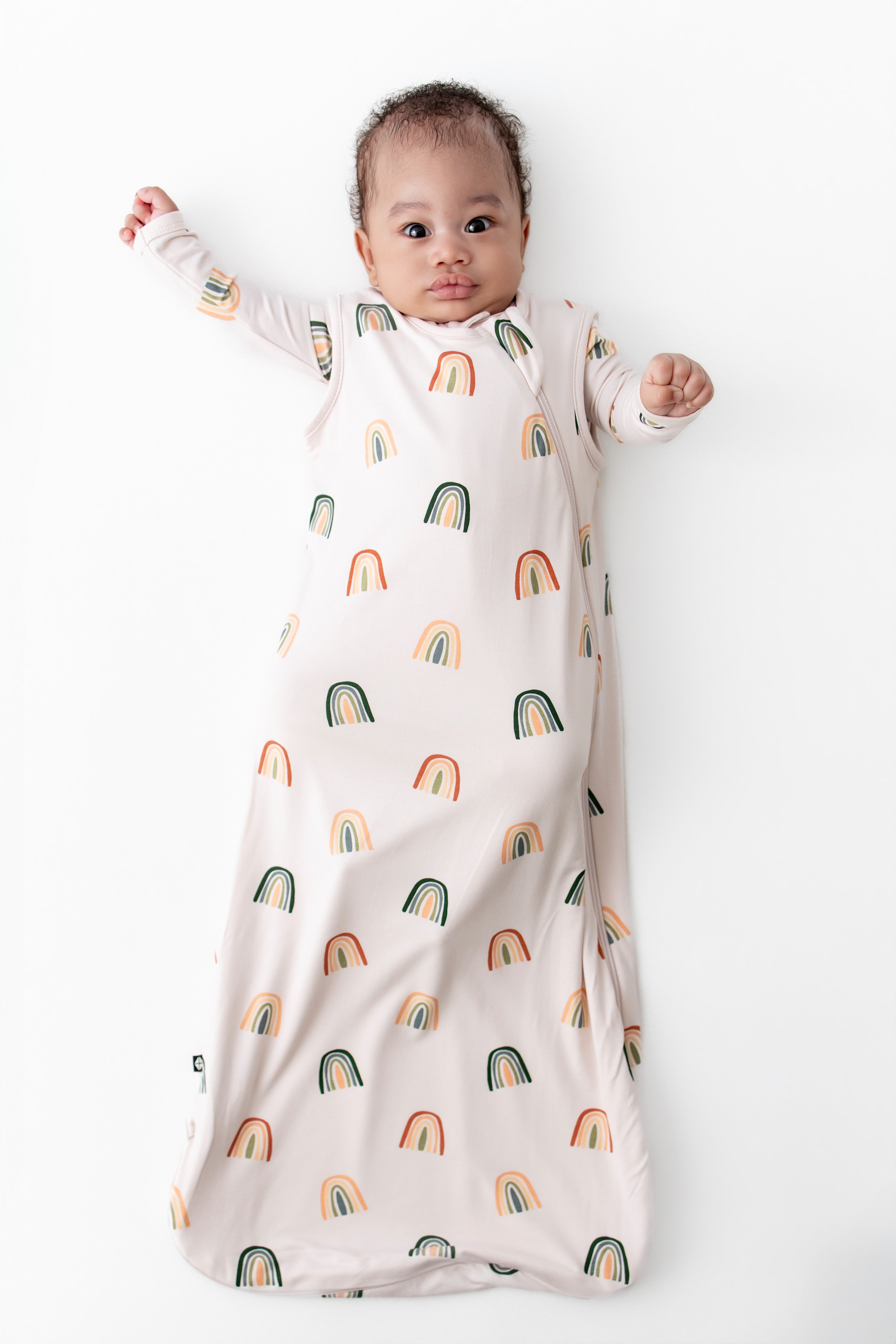 Baby in Sleep Bag with Retro Rainbow 0.5 print on a white background