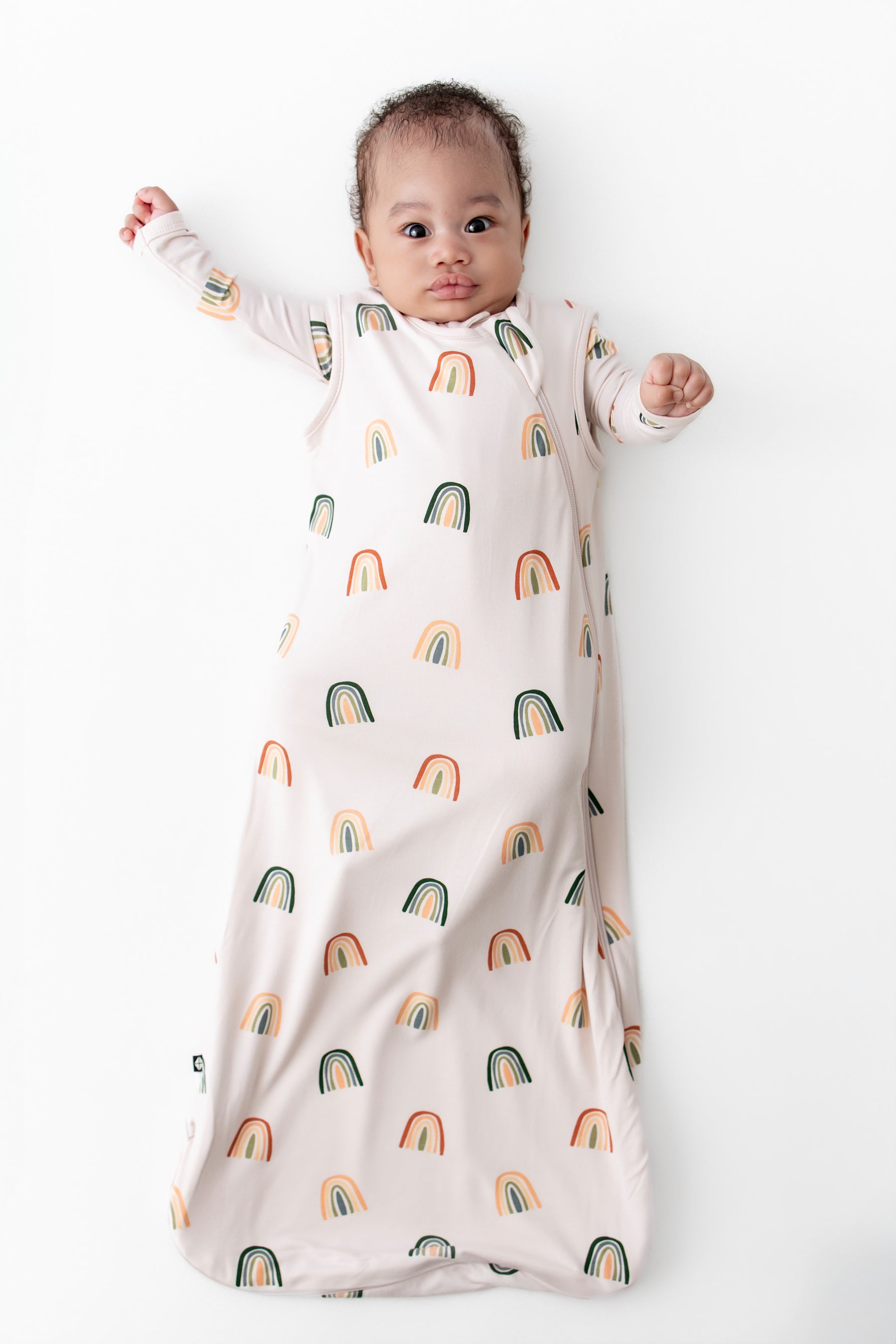 Baby in Sleep Bag with Retro Rainbow 0.5 print on a white background