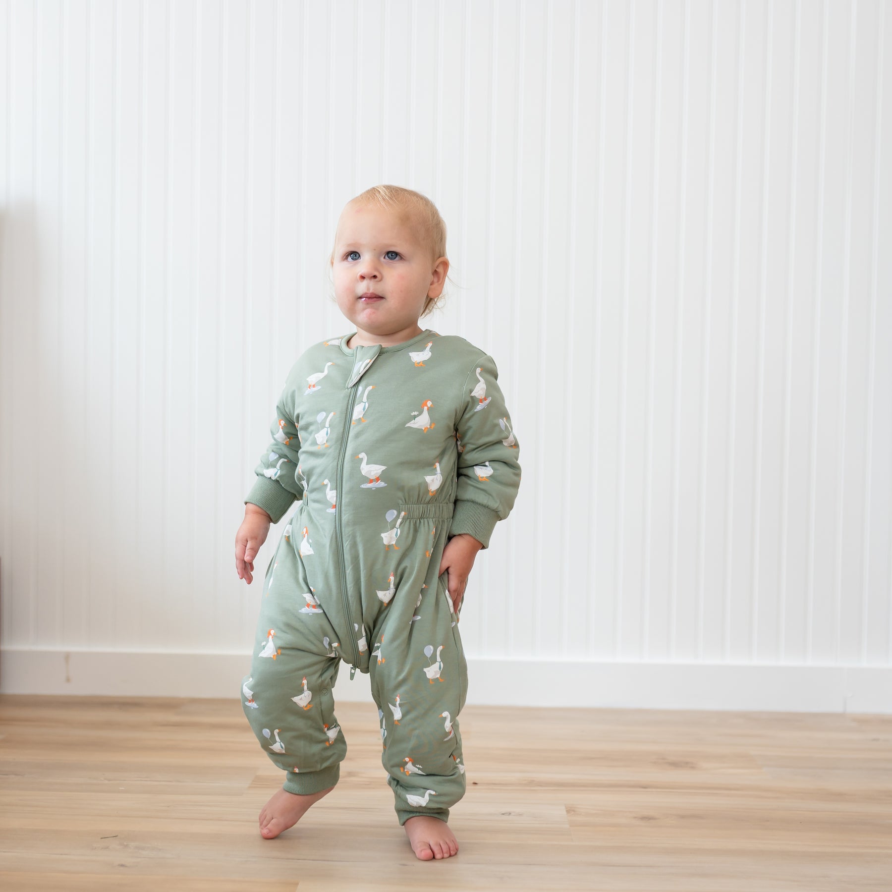 Toddler walking wearing the Cozy Playsuit in Silly Goose