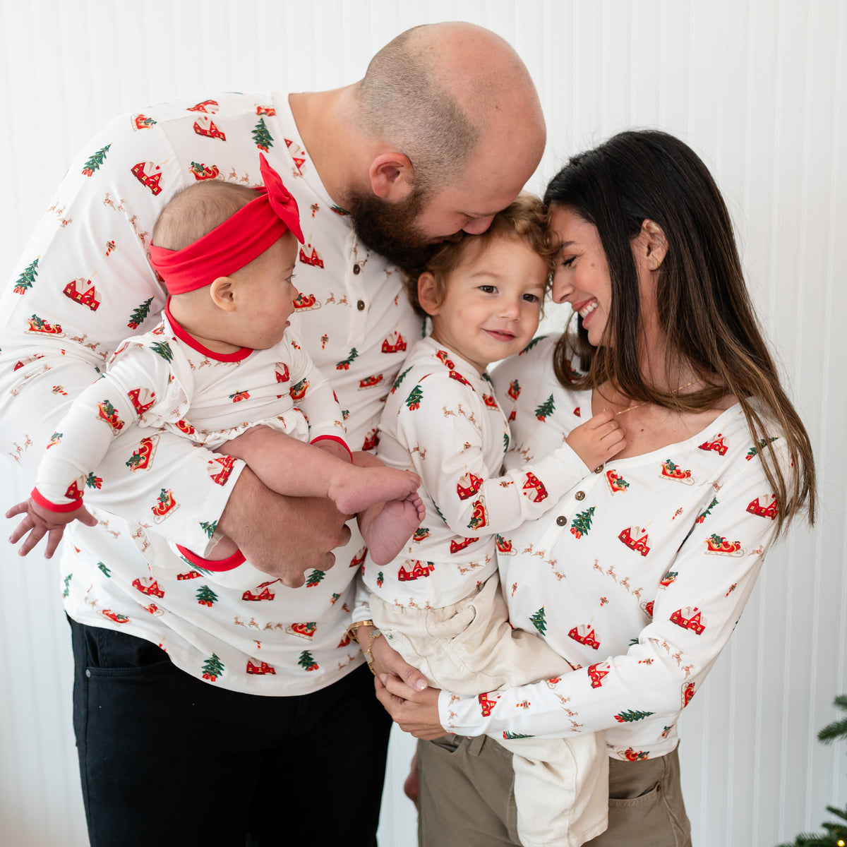 Family of four matching in Santa Sleigh