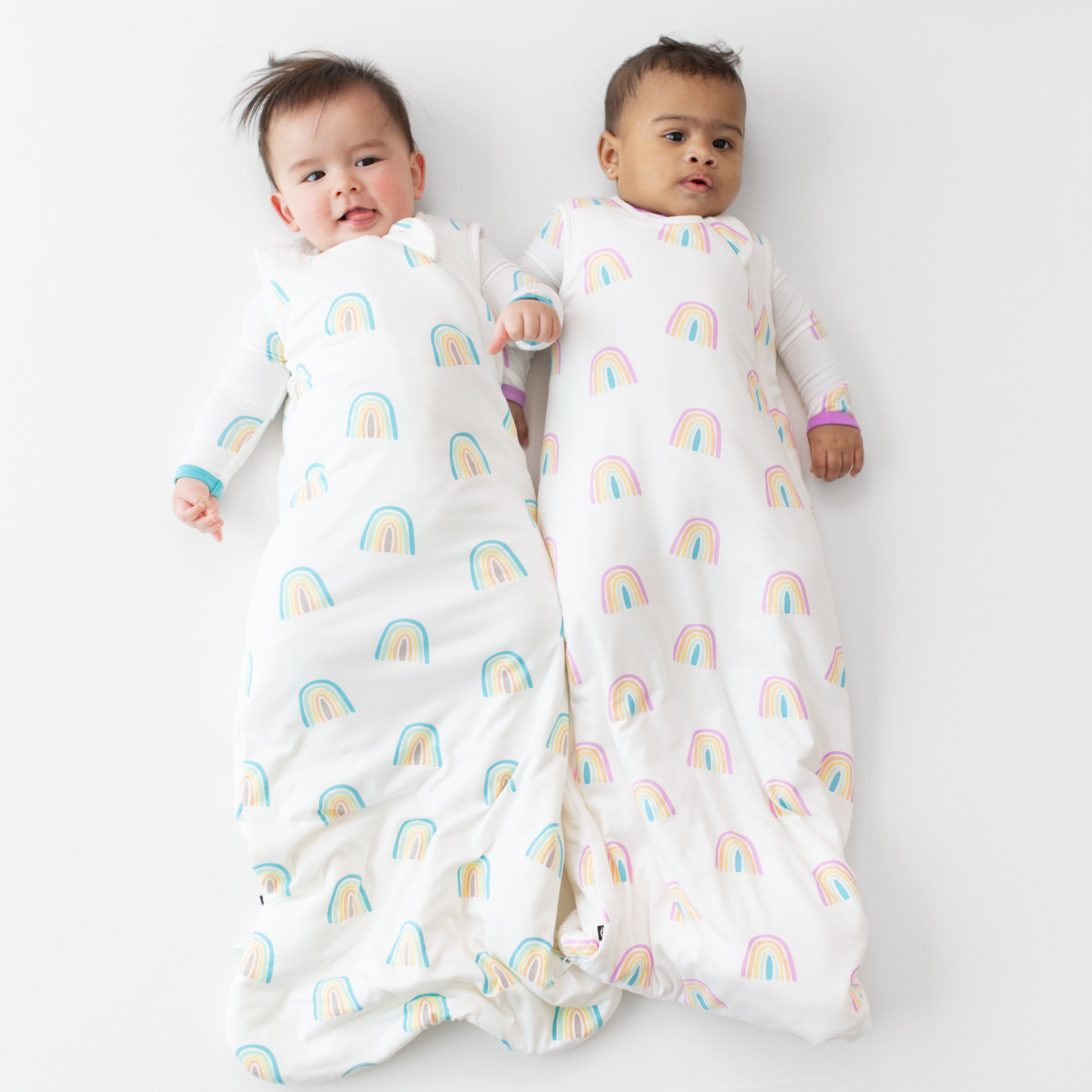 Two babies wearing Sleep Bags in Makai and Poi Rainbow