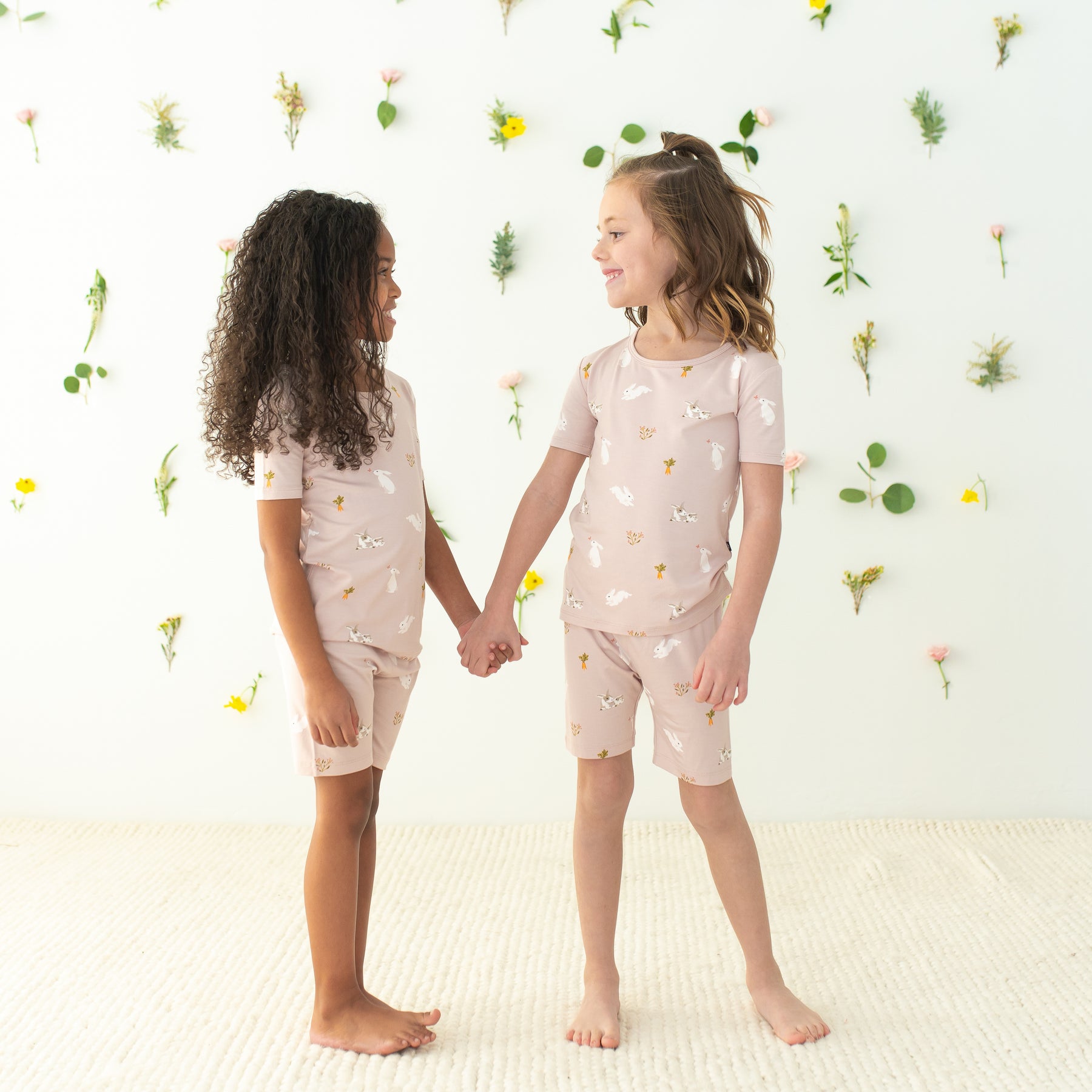 2 girls holding hands wearing Short Sleeve Pajamas in Blush Rabbit