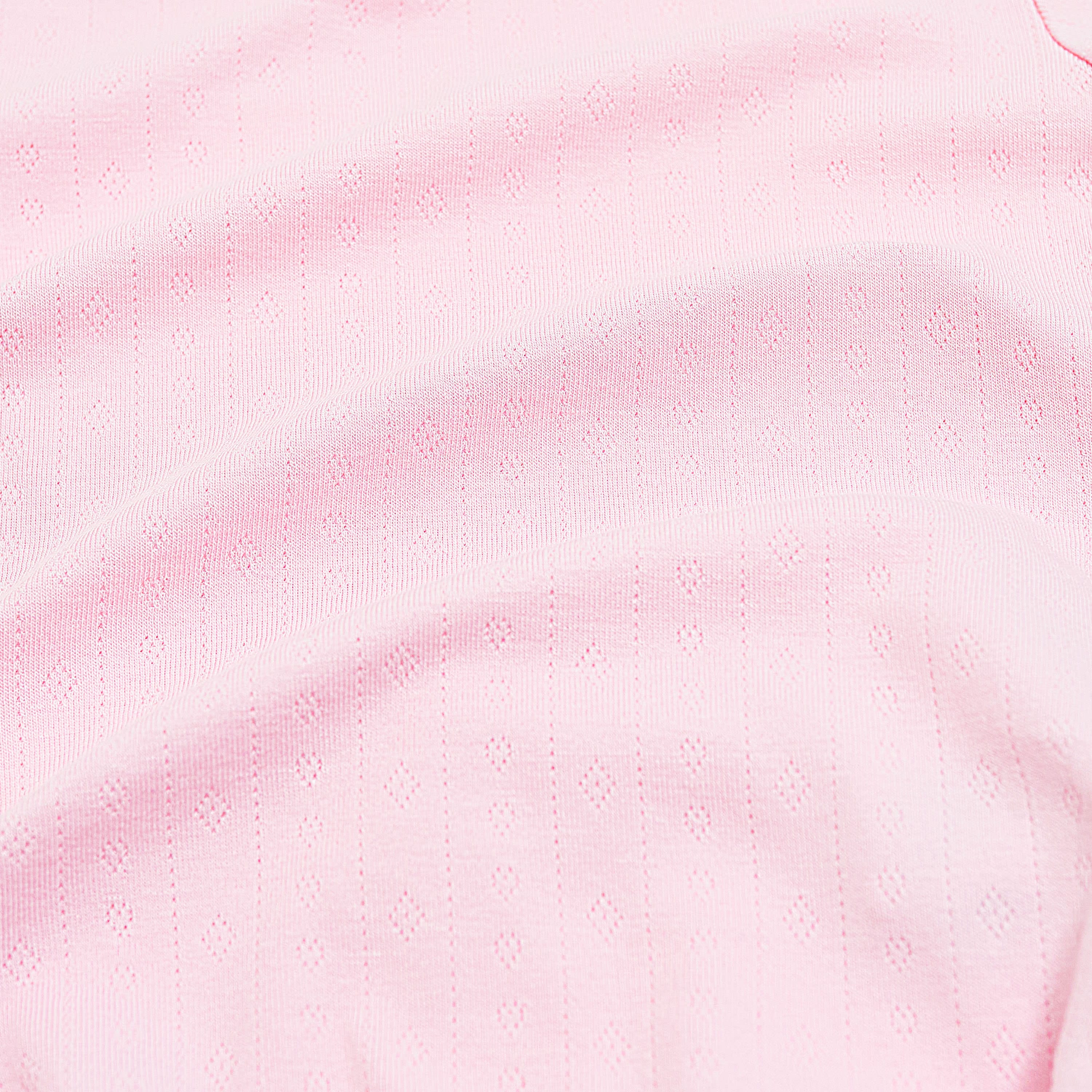 Close up of the pointelle fabric showing the light pink color