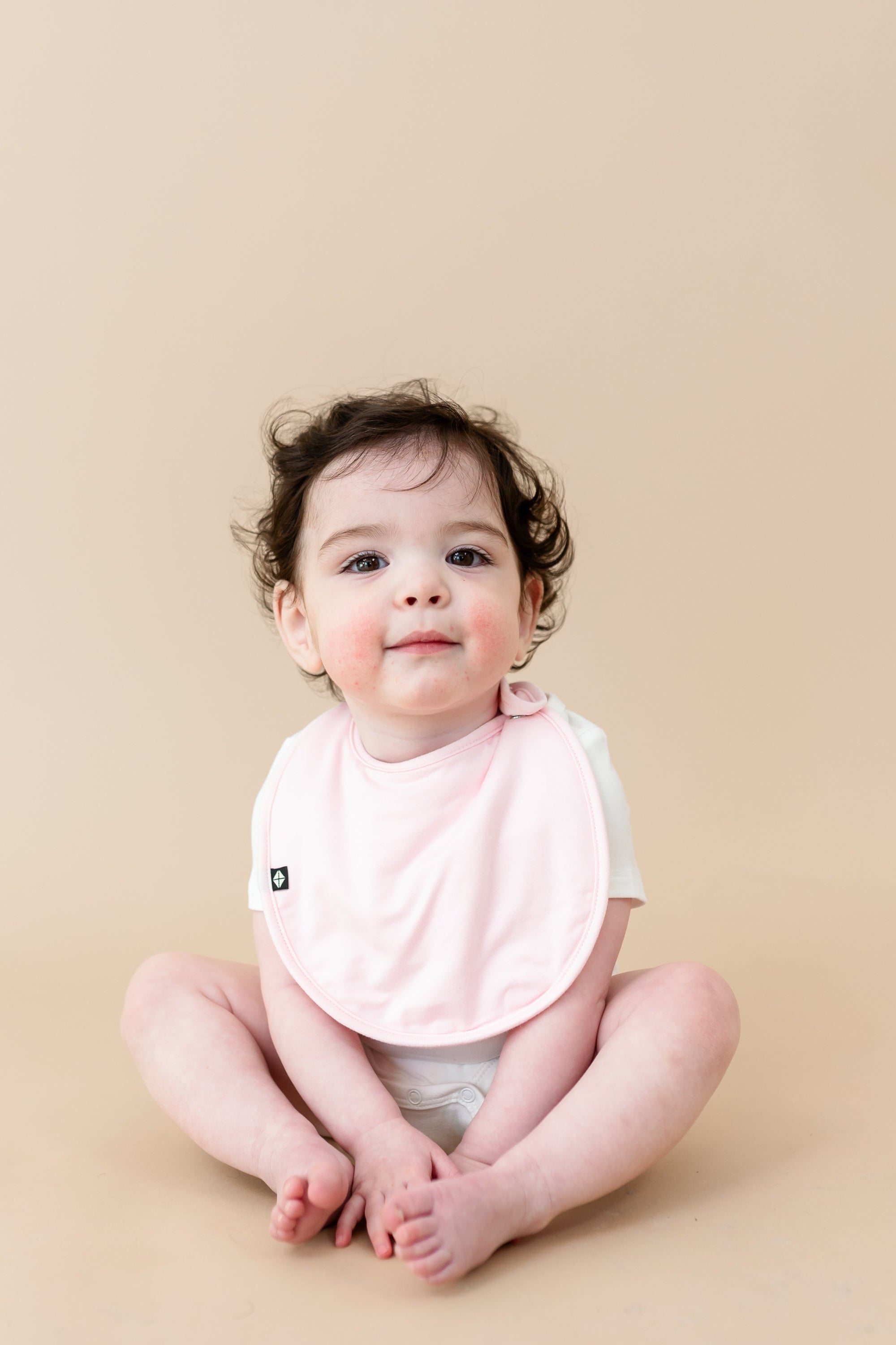 Cushy Bib in Sakura Pink on Baby