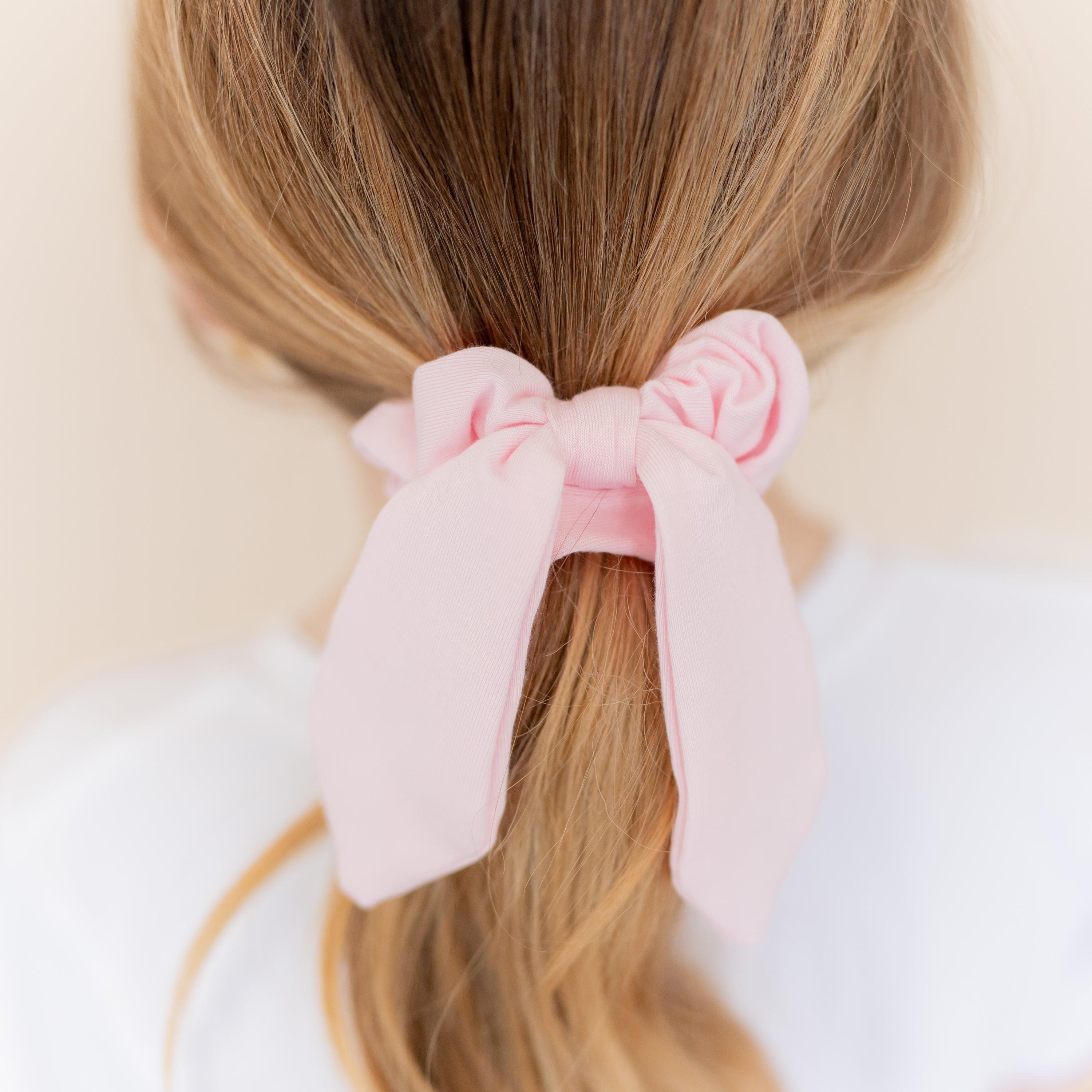 Close up of the Scrunchie in Sakura shown in a models hair