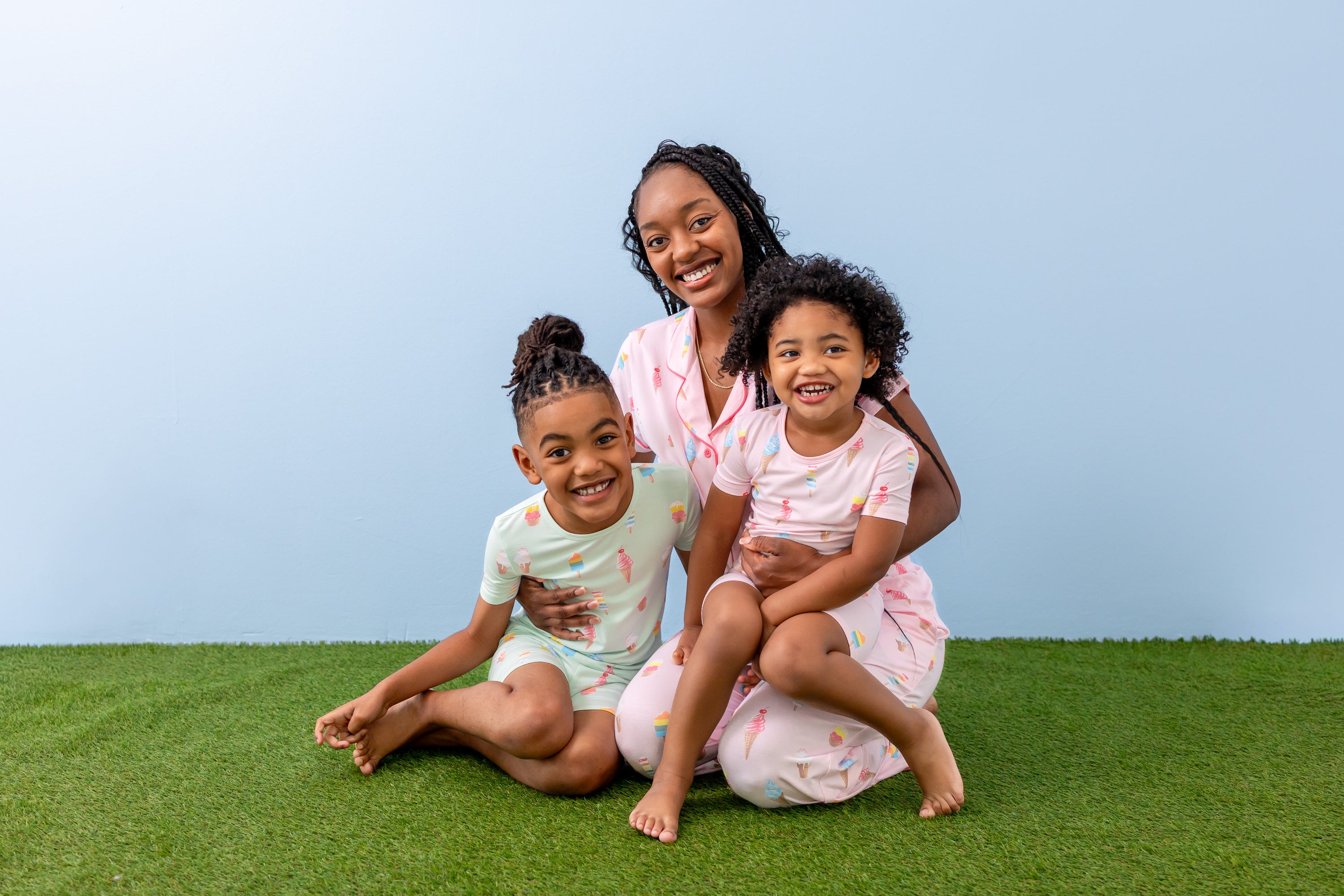 family of 3 wearing matching ice cream printed pajamas