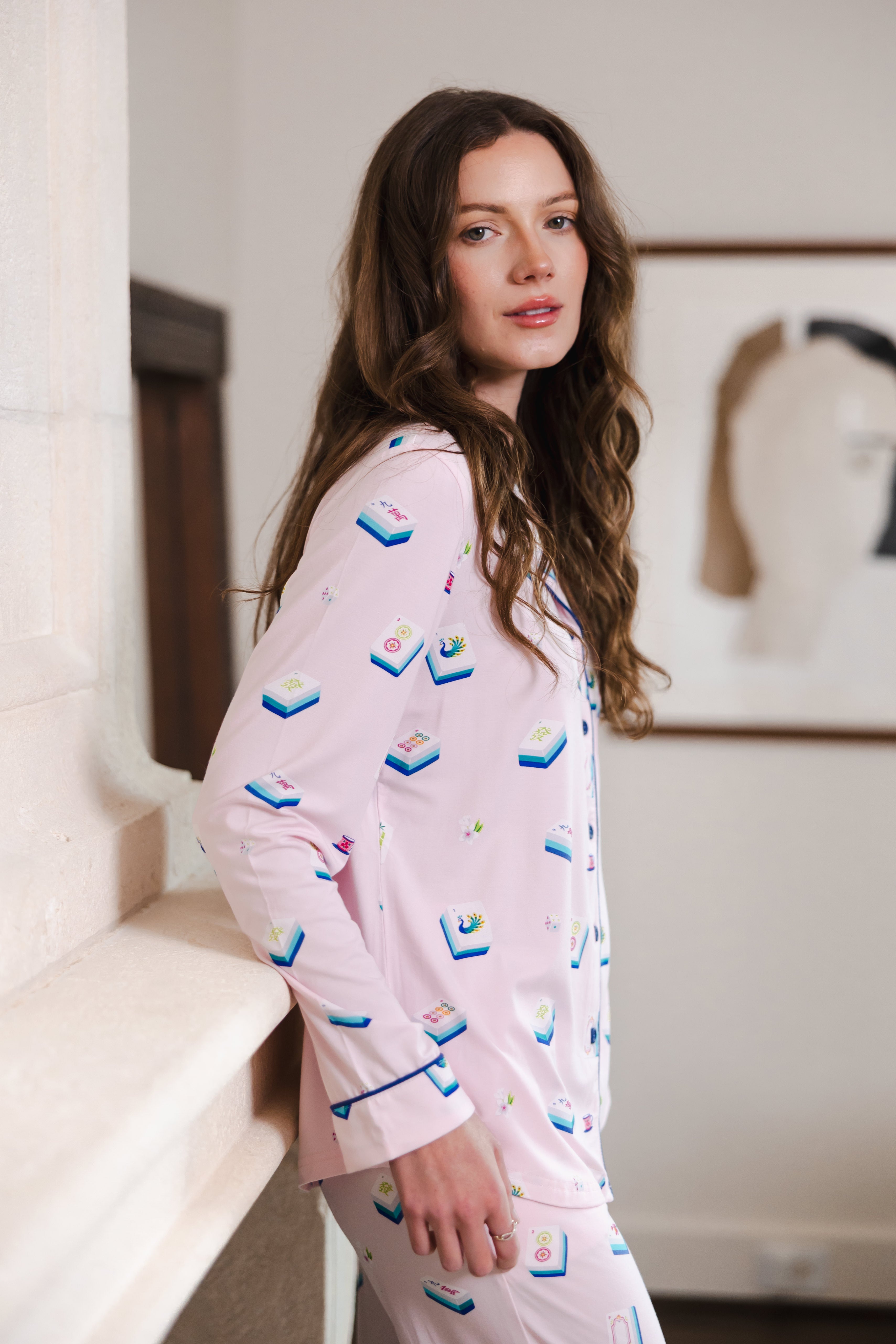 Modal wearing Long-Sleeved Women's Pajama Set in Sakura Mahjong print standing in a room