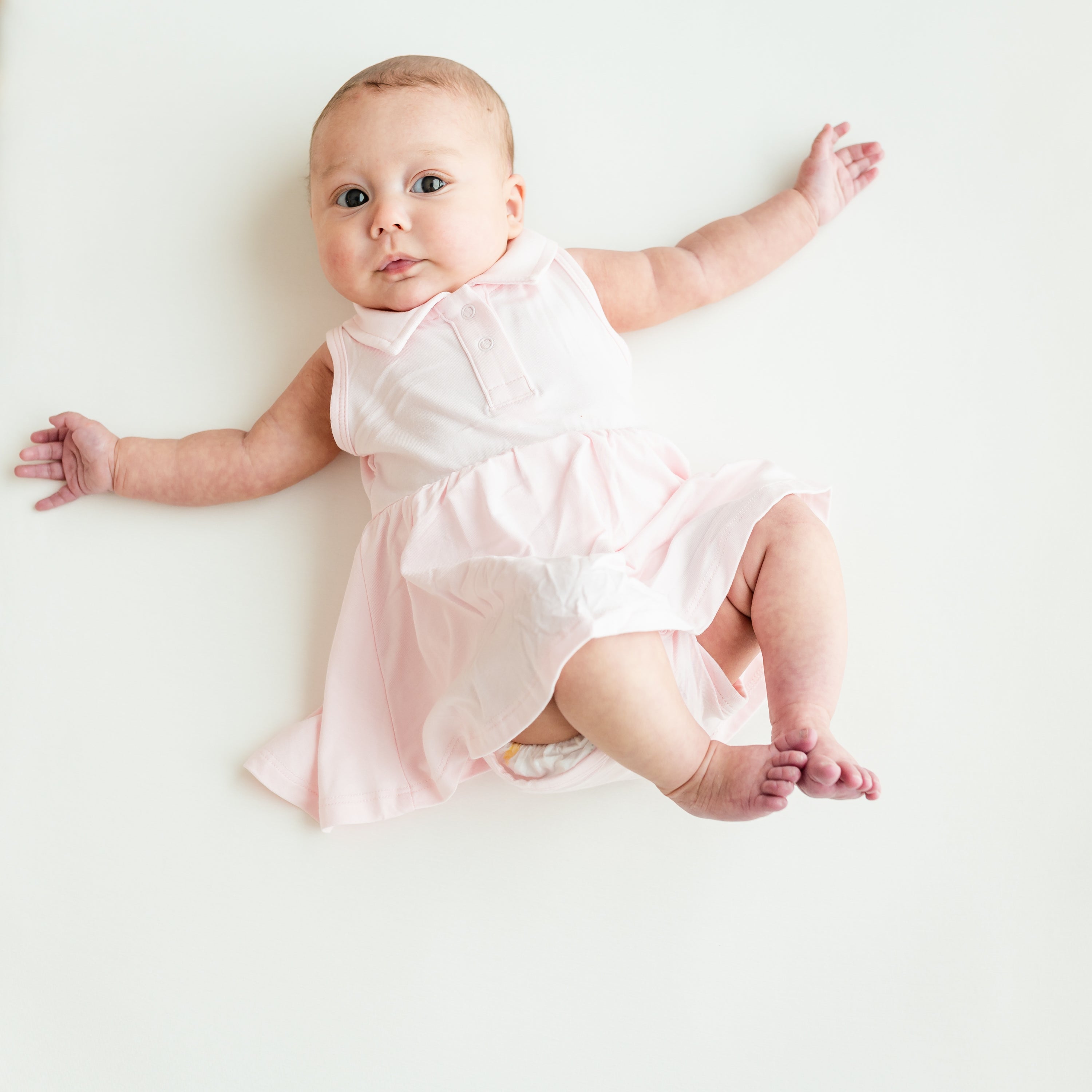 Baby modeling Polo Bodysuit Dress in Sakura