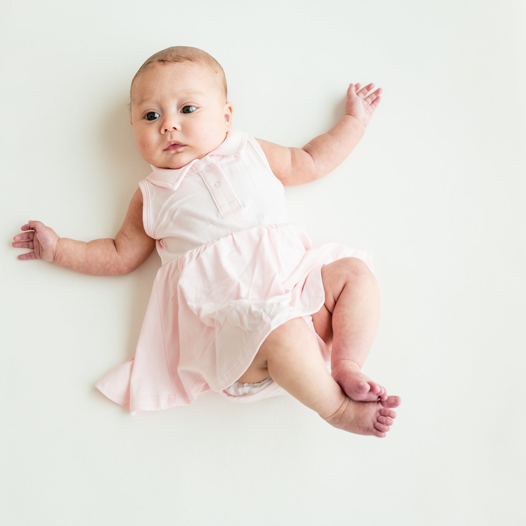 Baby modeling Polo Bodysuit Dress in Sakura