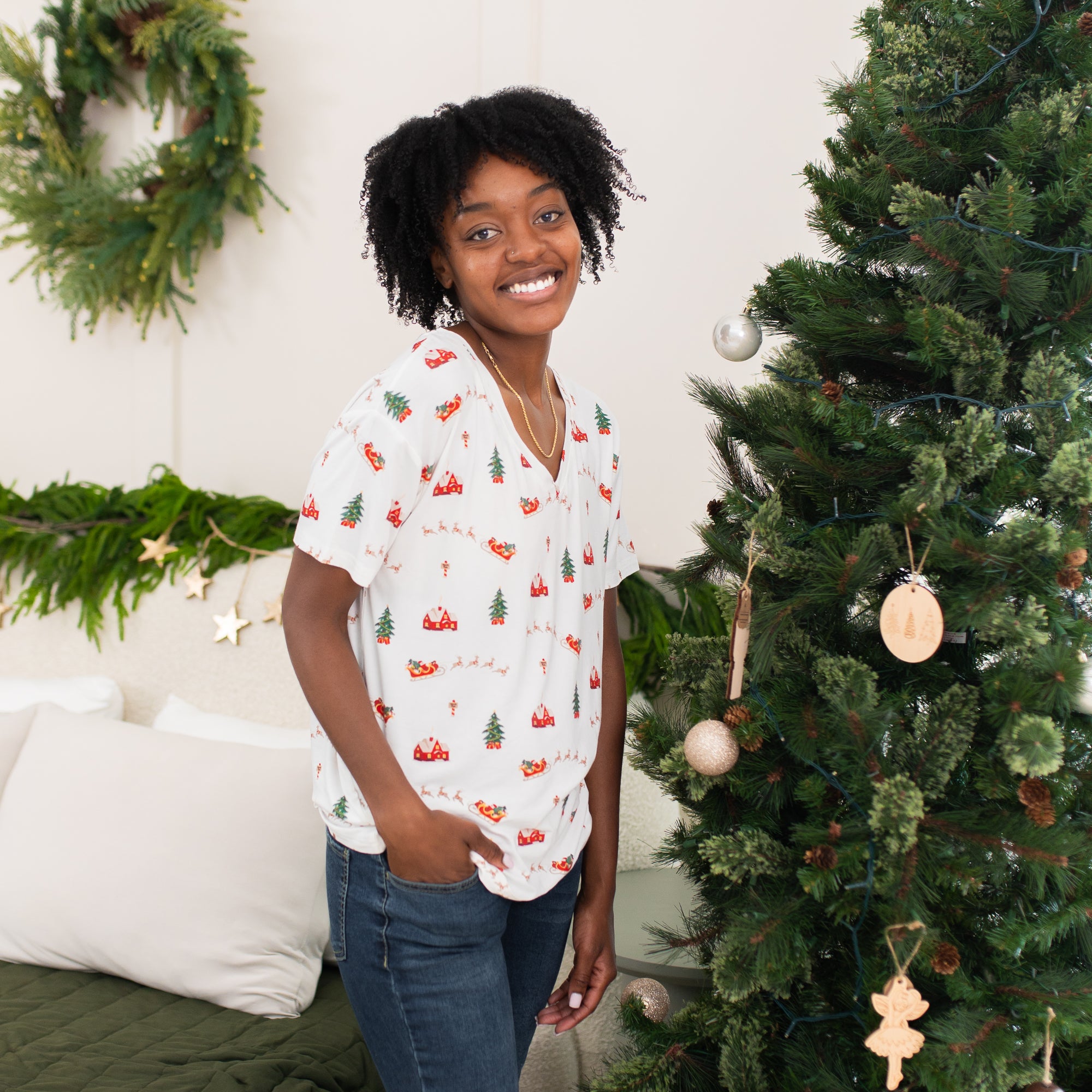 Female model standing with one hand in her jeans pocket wearing the Women's V-neck in santa Sleigh