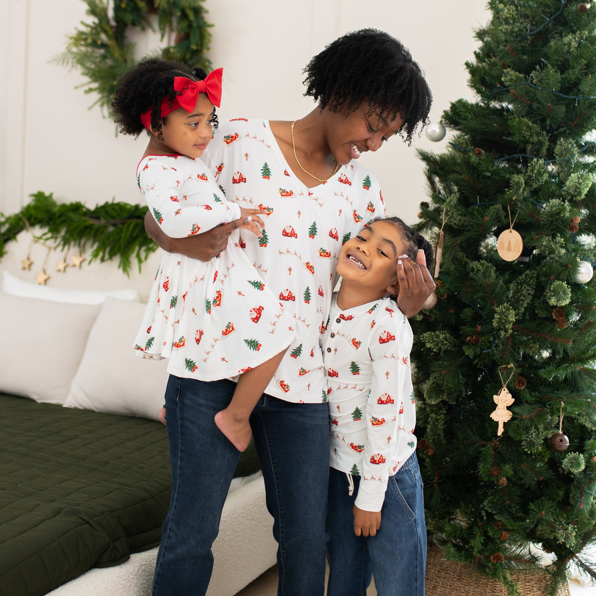 Mother and her two children all matching in Santa Sleigh