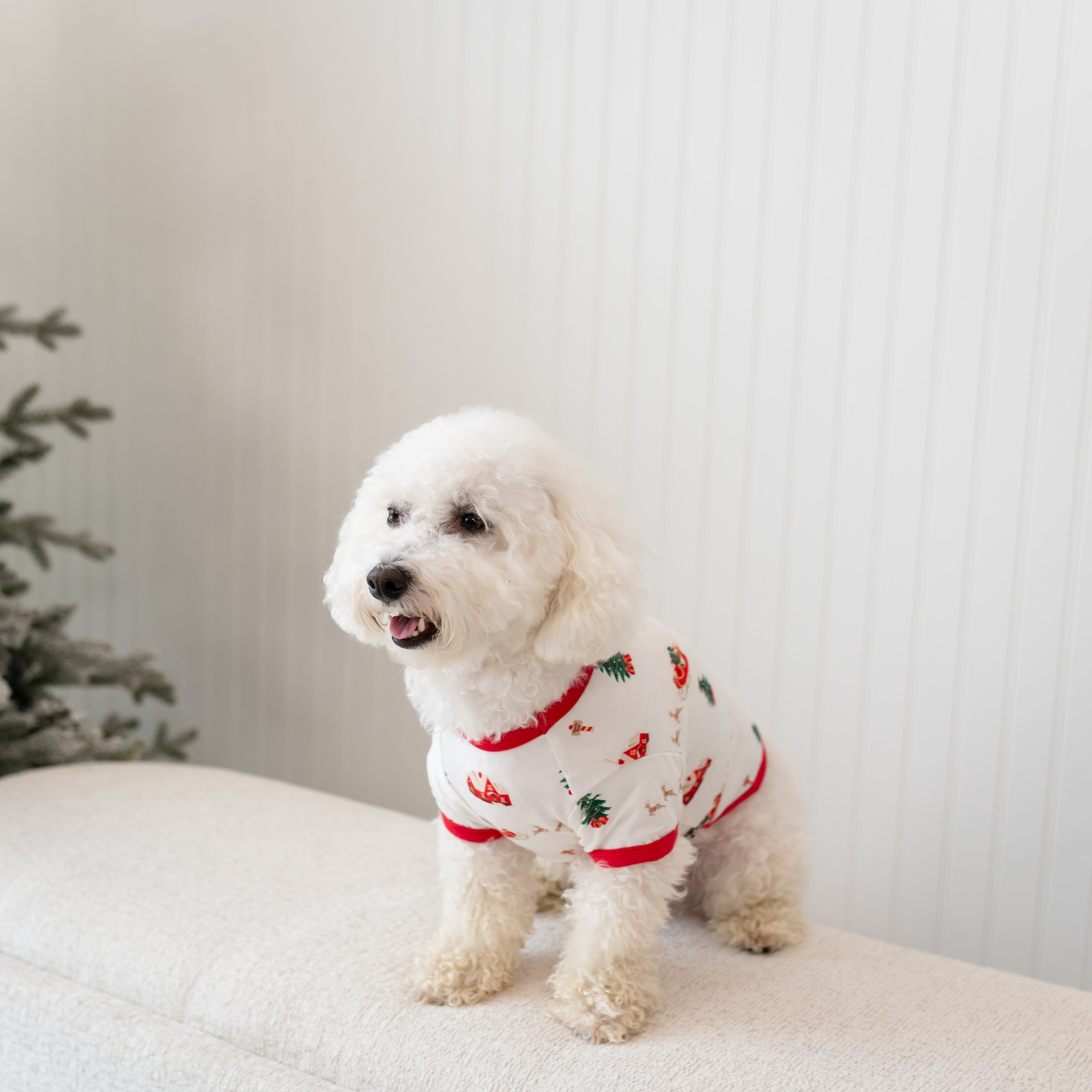 The side view of the Dog Tee in Santa Sleigh shown on a small white dog