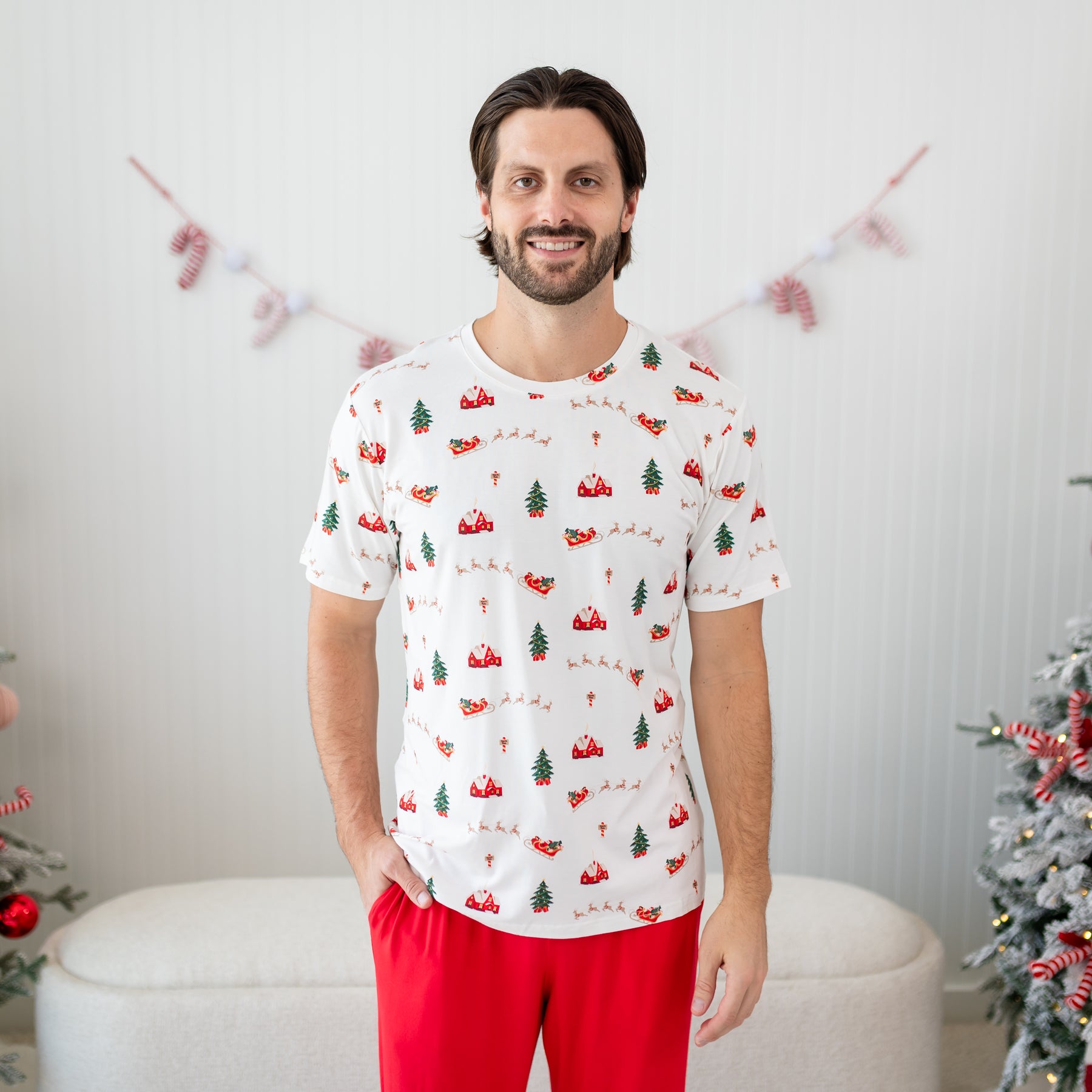 Male model standing wearing the Men's Crew Neck Tee in Santa Sleigh with one hand in the pocket of the Cardinal Lounge pant