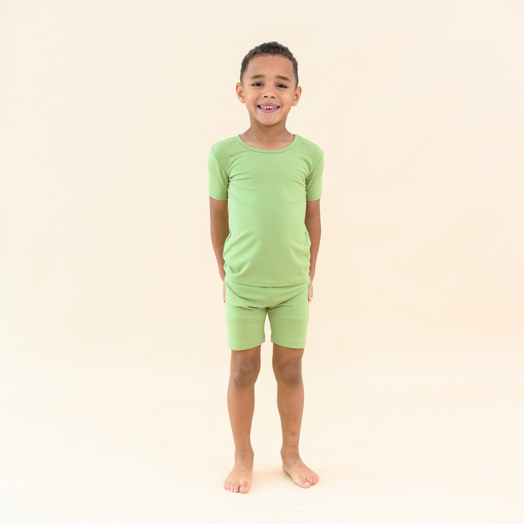 toddler modeling kyte baby short sleeve pajamas in honu