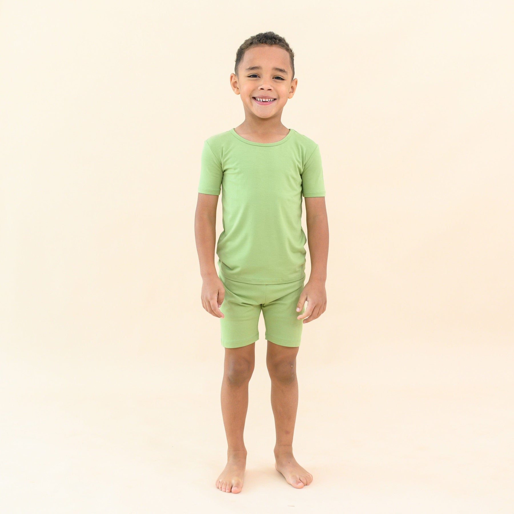 toddler modeling kyte baby short sleeve pajamas in honu