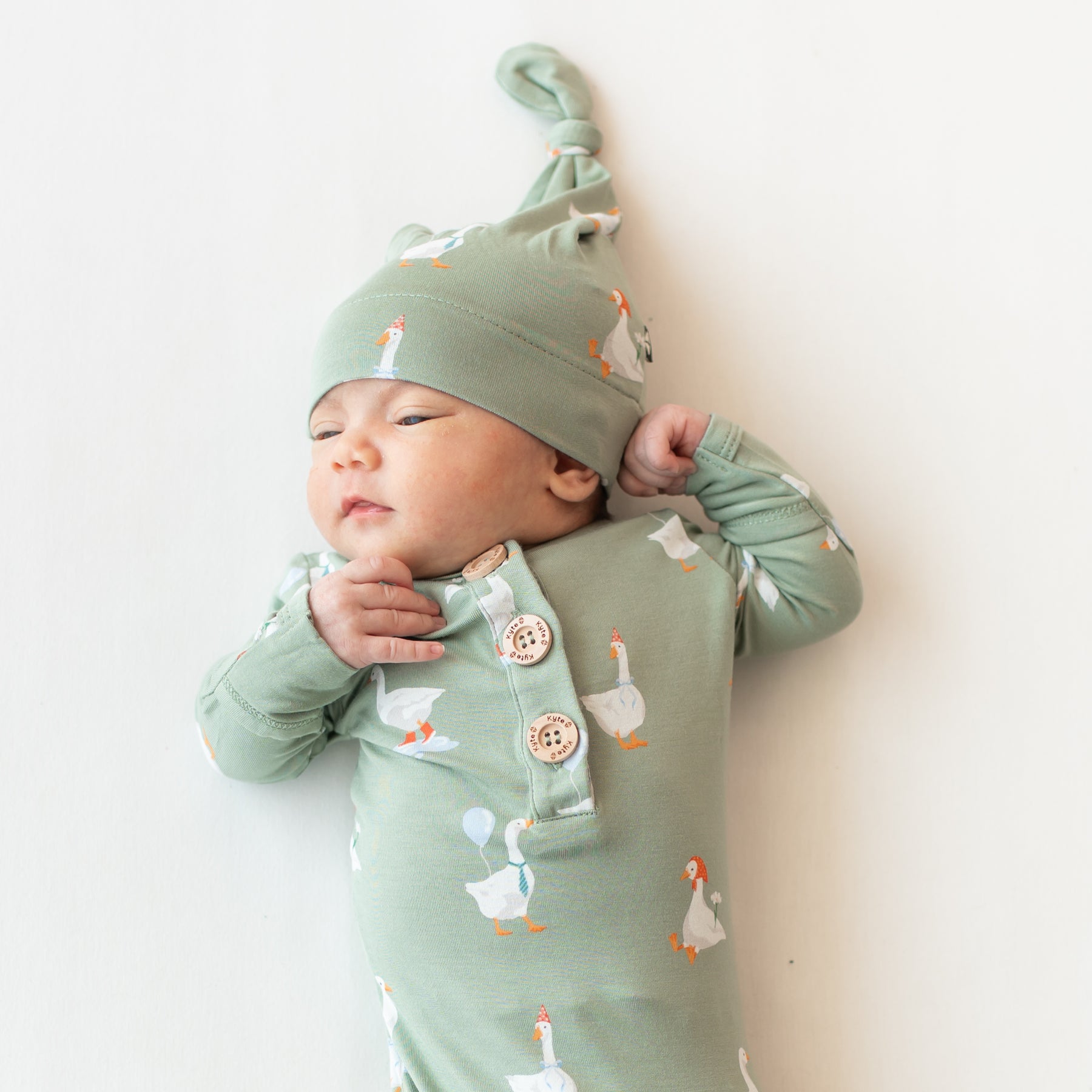 Close up of the Knotted Gown with Hat Set in Silly Goose shown on an infant model