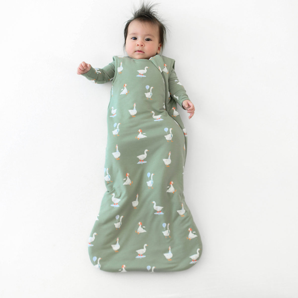 Infant wearing Sleep Bag in Silly Goose 1.0 with matching long sleeve romper
