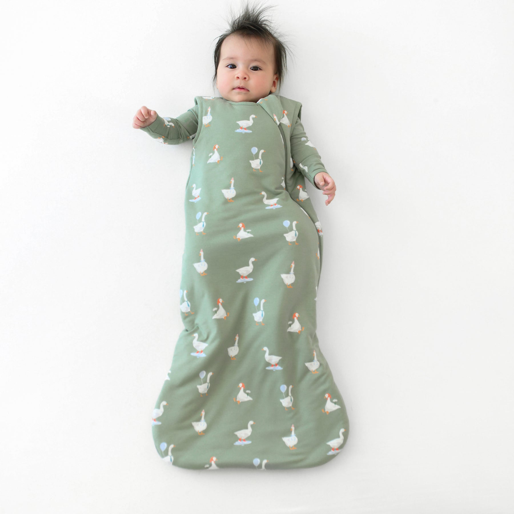 Infant wearing Sleep Bag in Silly Goose 1.0 with matching long sleeve romper